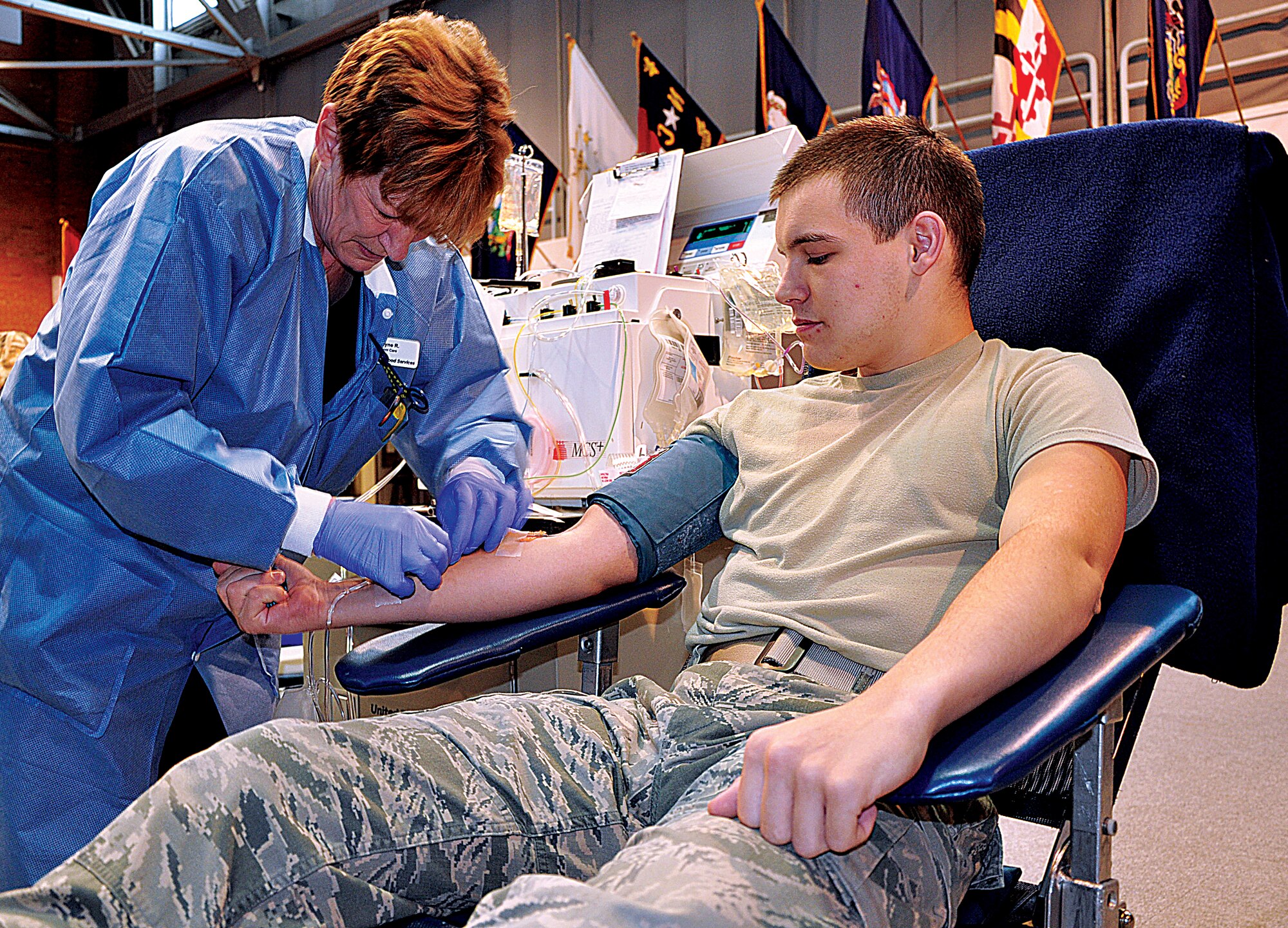 Airman 1st Class Zachary Warren, 90th Security Forces Group, sits as a United Blood Services technician prepares his arm for a blood donation held in the Fall Hall Community Center, F.E. Warren Air Force Base, Wyo., Nov. 1, 2013. (U.S. Air Force photo by Senior Airman Mike Tryon)