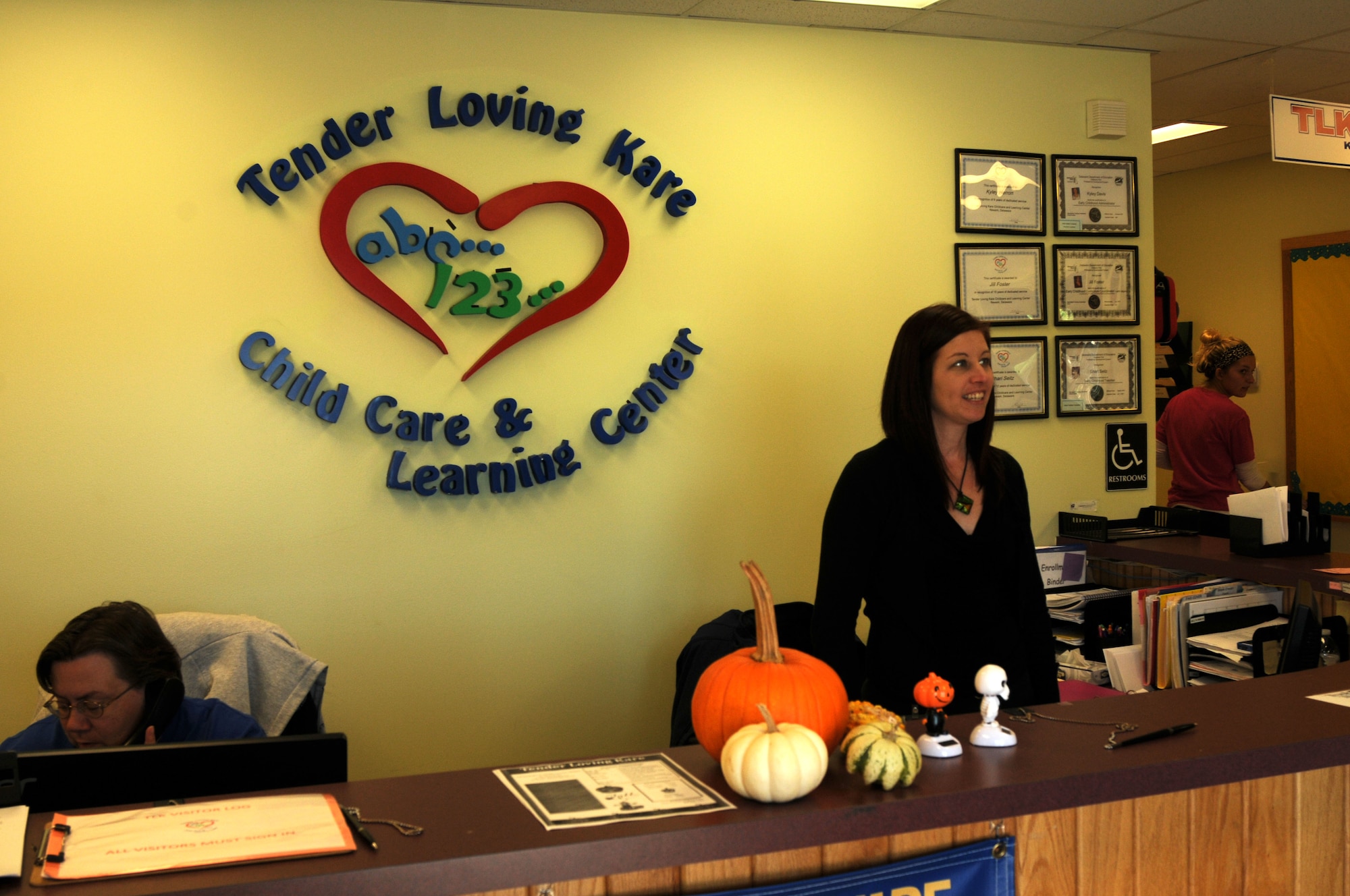 Jill Foster (right), assistant director, Tender Loving Kare Child Care & Learning Center in Newark, Del., at the center’s main desk, Oct. 21, 2013. Families of Delaware National Guard members may enroll their children in affordable, state licensed drill weekend child care at the facility. (U.S. Air National Guard photo by Staff Sgt. Nathan Bright)