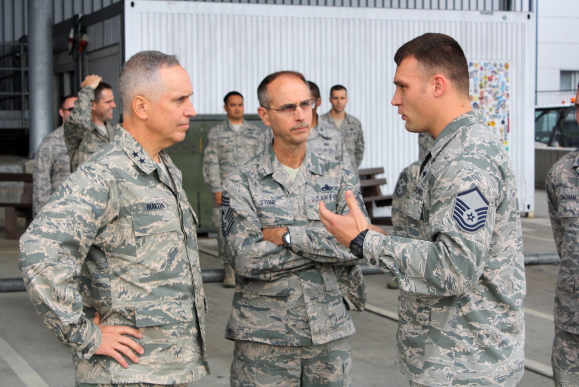 RAMSTEIN AIR BASE, Germany – Maj. Gen. Frederick H. “Rick” Martin (left), U.S. Air Force Expeditionary Center commander, and Expeditionary Center Command Chief Master Sgt. Pete Stone (center),  discuss the aerial port operations with Master Sgt. Justin Hemken, 721st Aerial Port Squadron NCO in charge of ramp services. The 721st APS provides passenger services for the 521st Air Mobility Operations Wing to expedite warfighting and humanitarian missions throughout Europe, the Middle East and Africa. The Expeditionary Center provides direct oversight for the 521st AMOW and plans long- and short-term mission for global mobility. (U.S. Air Force photo/1st Lt. Nicole Mancos)