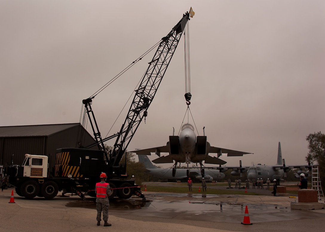 362nd Training Squadron, Crash Damaged Disabled Aircraft Recovery (CDDAR), students trained on recovering an F-15 Eagle aircraft that experienced landing gear failure on Oct. 28, 2013. The training crews utilized a dedicated wire rope sling and a 55 ton crane to lift the aircraft to the proper height simulating placing the aircraft into a flatbed trailer to remove off the runway. (U.S. Air Force photo/Danny Webb/RELEASED)