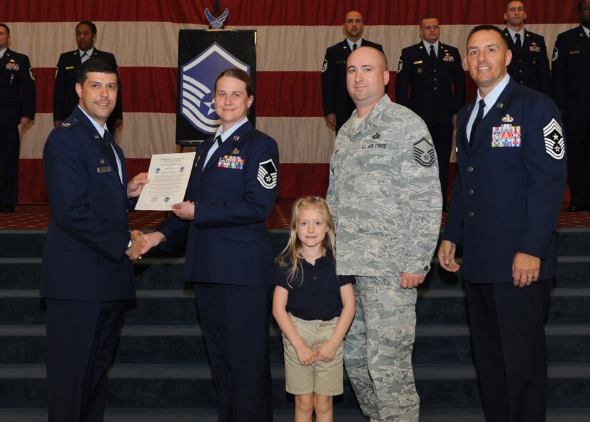 Master Sgt. Heather Geer, 2nd Security Forces Squadron, receives a certificate of promotion from Col. Andrew Gebara, 2nd Bomb Wing commander, and Chief Master Sgt. Curtis Storms, 2nd BW command chief, during the October Wing Promotion Ceremony on Barksdale Air Force Base, La., Oct. 31, 2013. (U.S. Air Force photo/Senior Airman Joseph A. Pagán Jr.)