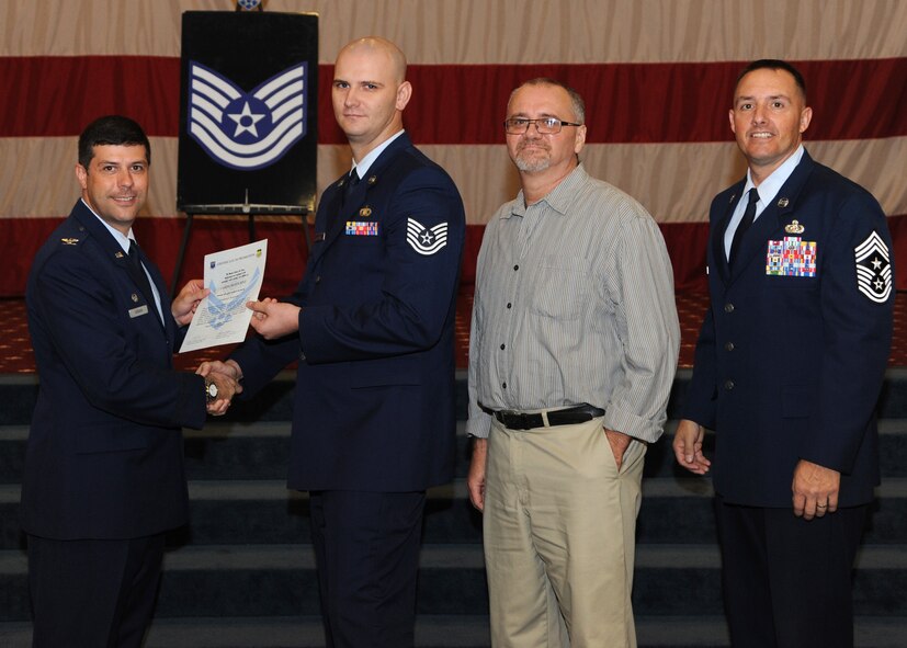 Tech. Sgt. James Betourne, 2nd Bomb Wing Command Post, receives a certificate of promotion from Col. Andrew Gebara, 2nd BW commander, and Chief Master Sgt. Curtis Storms, 2nd BW command chief, during the October Wing Promotion Ceremony on Barksdale Air Force Base, La., Oct. 31, 2013. (U.S. Air Force photo/Senior Airman Joseph A. Pagán Jr.)