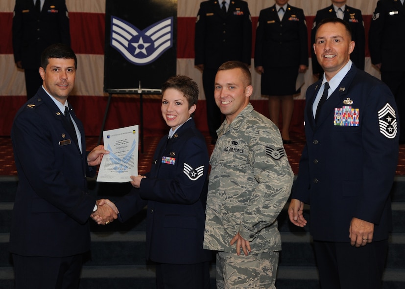 Staff Sgt. Tiffanie Locke, 2nd Munitions Squadron, receives a certificate of promotion from Col. Andrew Gebara, 2nd Bomb Wing commander, and Chief Master Sgt. Curtis Storms, 2nd BW command chief, during the October Wing Promotion Ceremony on Barksdale Air Force Base, La., Oct. 31, 2013. (U.S. Air Force photo/Senior Airman Joseph A. Pagán Jr.)