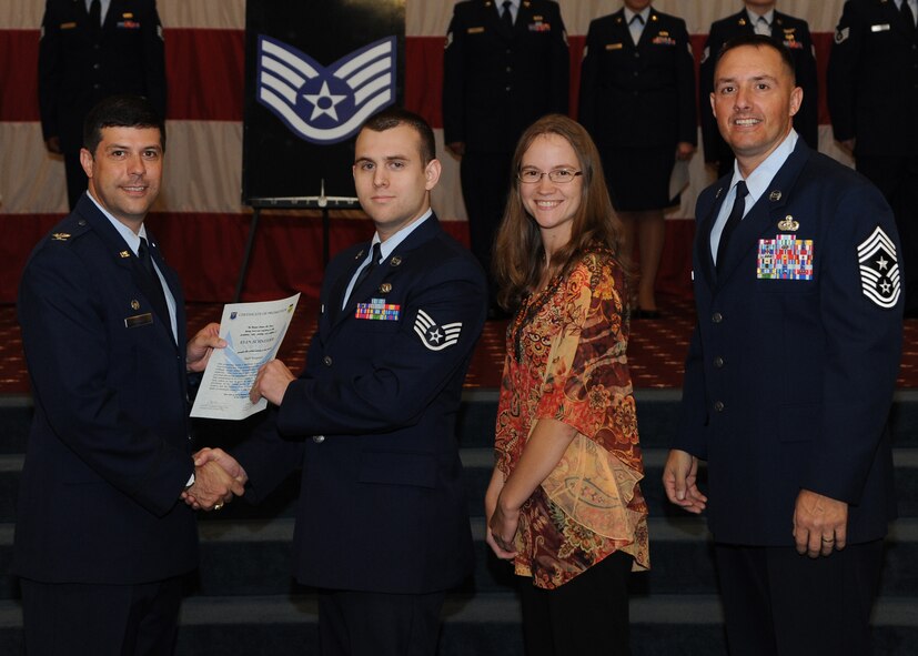 Staff Sgt. Ryan Schneider, 2nd Logistics Readiness Squadron, receives a certificate of promotion from Col. Andrew Gebara, 2nd Bomb Wing commander, and Chief Master Sgt. Curtis Storms, 2nd BW command chief, during the October Wing Promotion Ceremony on Barksdale Air Force Base, La., Oct. 31, 2013. (U.S. Air Force photo/Senior Airman Joseph A. Pagán Jr.)