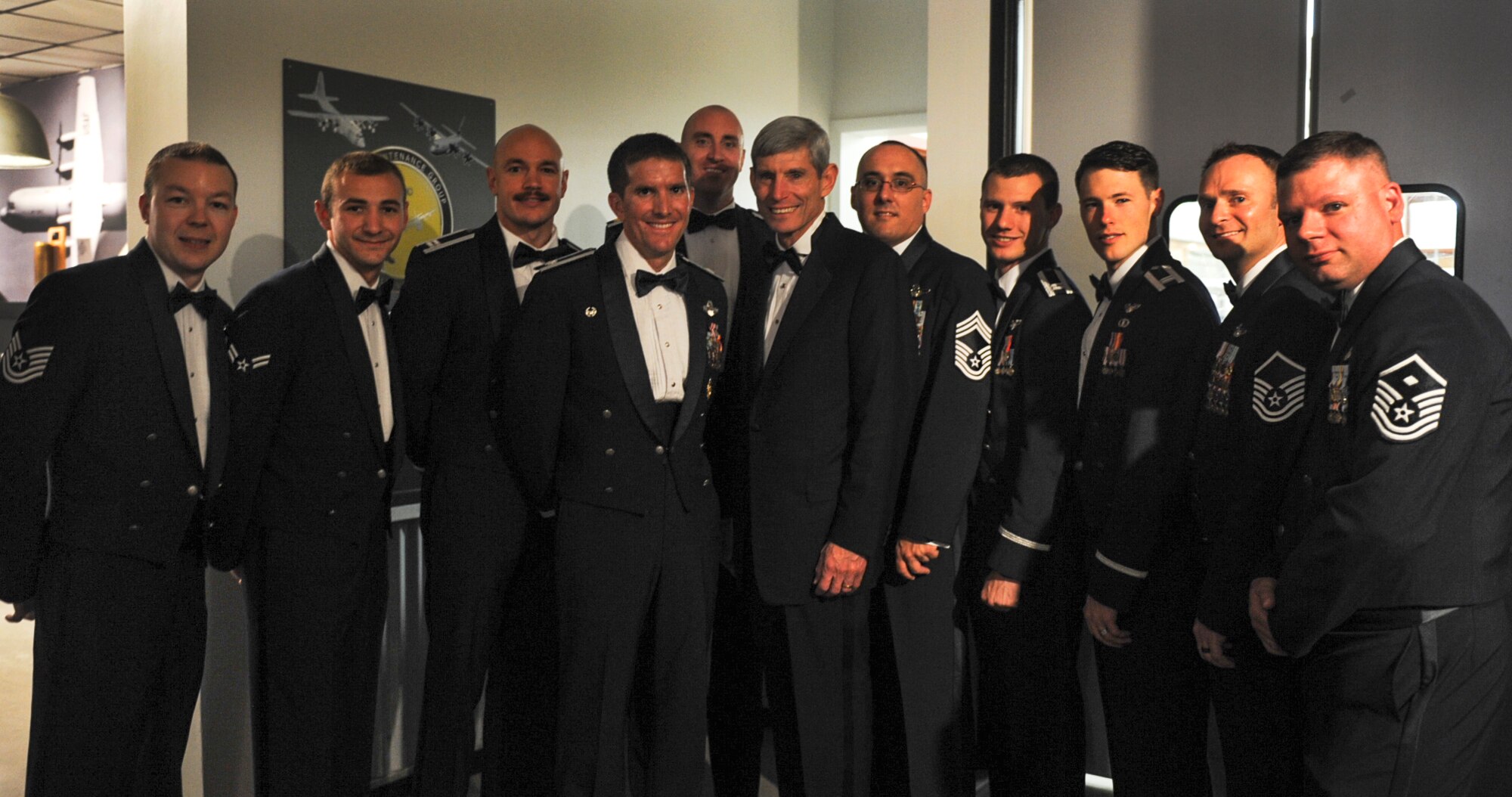 Members of the 61st Airlift Squadron pause for a photo opportunity with retired Gen. Norton Schwartz, a former Green Hornet, Oct. 25, 2013, at Little Rock Air Force Base, Ark. Retired Gen. Schwartz was the guest speaker at Team Little Rock's 2013 Air Force Ball. (U.S. Air Force photo by Staff Sgt. Jessica Condit)