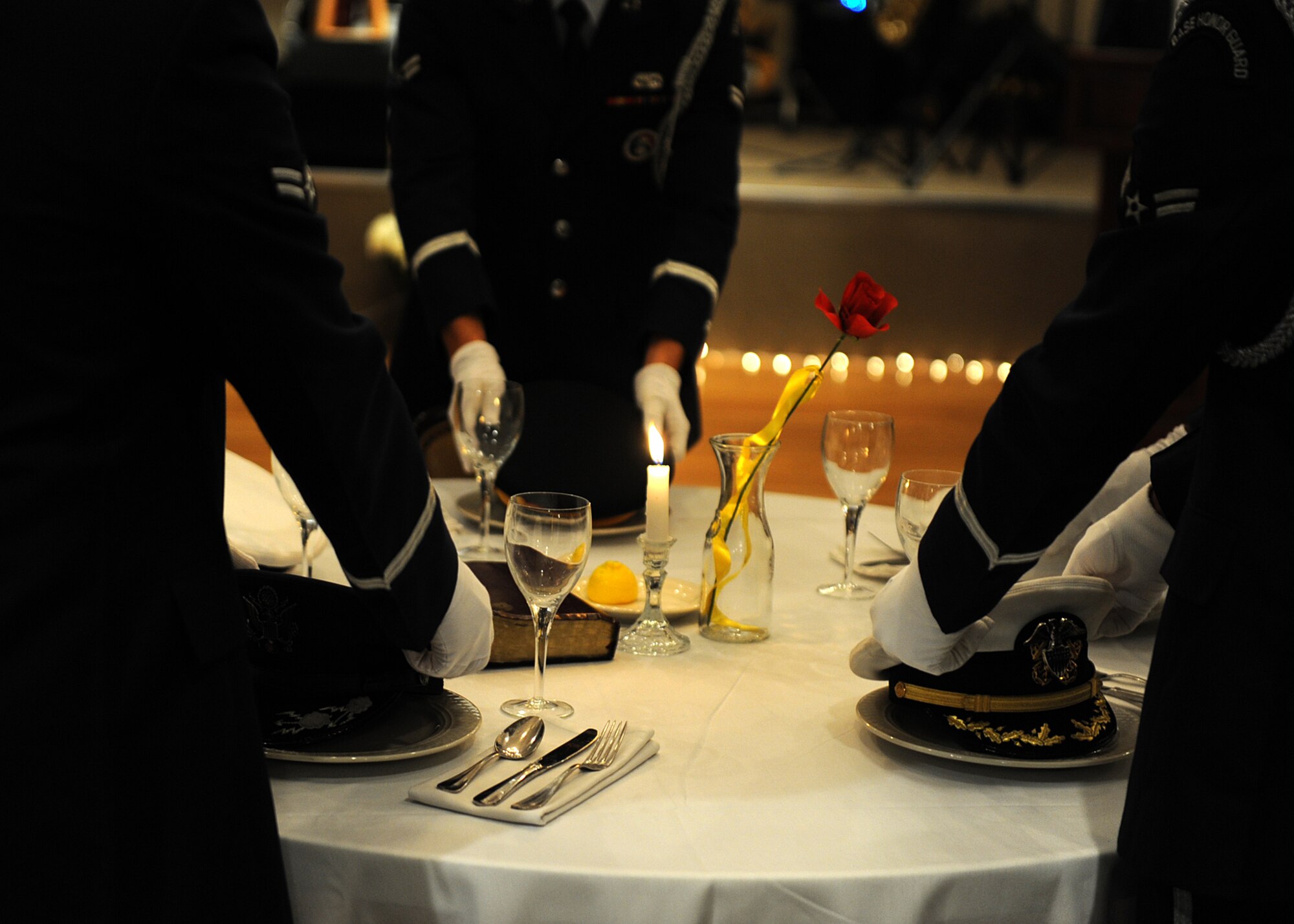 Little Rock Air Force Base Honor Guardsmen perform the Gold Star Ceremony during the Air Force Ball Oct. 25, 2013, at Little Rock Air Force Base, Ark. The Gold Star Ceremony represents the five branches of service, prisoners of war, missing in action and the service members who gave their lives for their country. (U.S. Air Force photo by Staff Sgt. Jessica Condit)