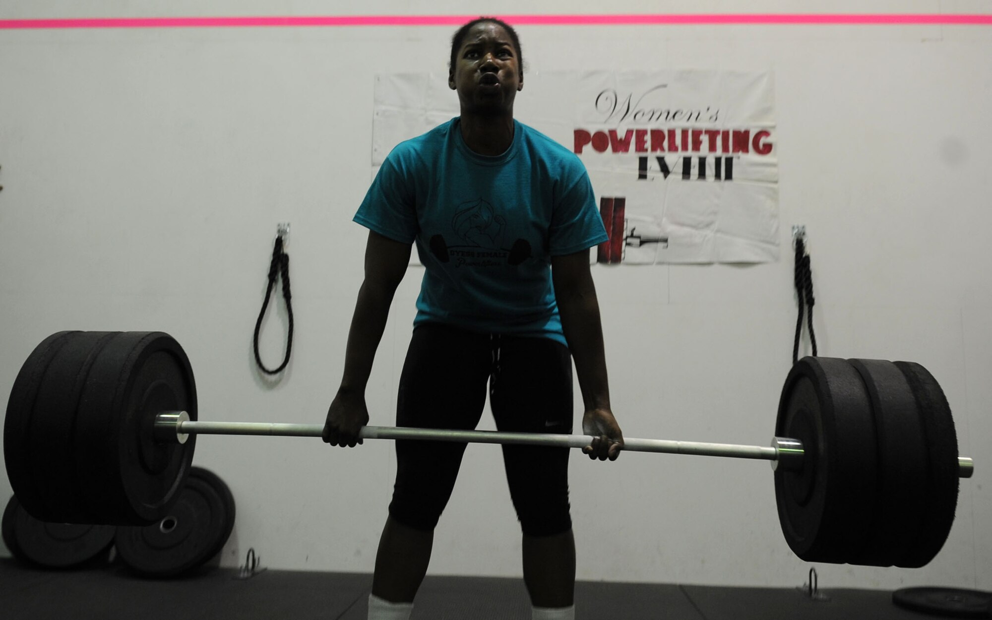 U.S. Air Force Senior Airman Lisa Woodland, 317th Aircraft Maintenance Squadron, deadlifts a weighted barbell of 295 pounds Oct. 26, 2013 at Dyess Air Force Base, Texas. Woodland competed in the Women’s Powerlifting Competition, held by the fitness center, where she had to successfully complete a deadlift, push-press and power clean. She finished in third place. (U.S. Air Force photo by Senior Airman Shannon Hall/Released)