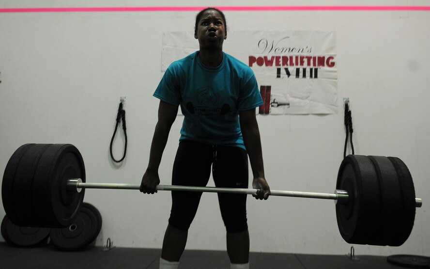 U.S. Air Force Senior Airman Lisa Woodland, 317th Aircraft Maintenance Squadron, deadlifts a weighted barbell of 295 pounds Oct. 26, 2013 at Dyess Air Force Base, Texas. Woodland competed in the Women’s Powerlifting Competition, held by the fitness center, where she had to successfully complete a deadlift, push-press and power clean. She finished in third place. (U.S. Air Force photo by Senior Airman Shannon Hall/Released)