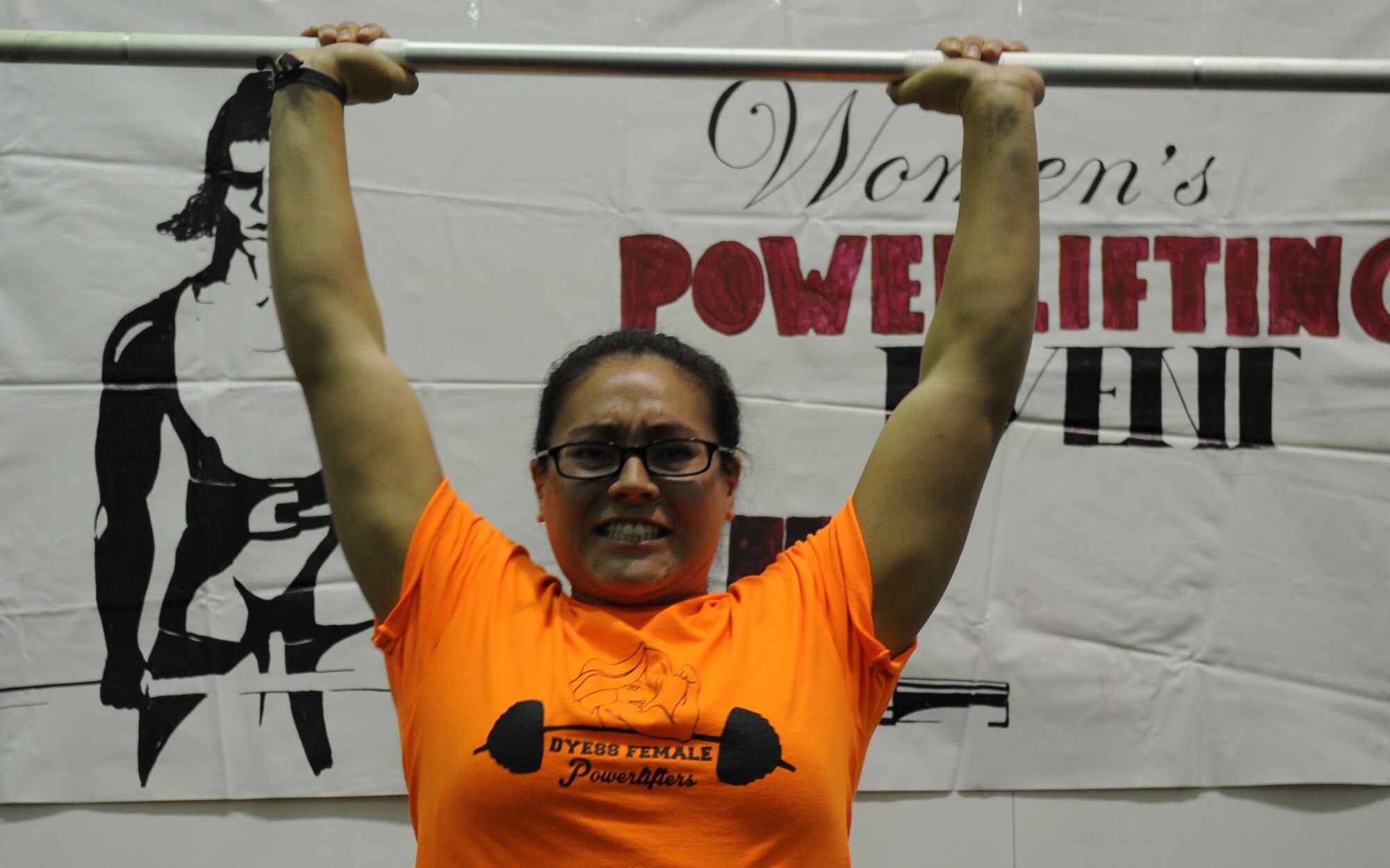 U.S. Air Force Senior Airman Leanne Locascio, 7th Logistics Readiness Squadron, lifts a barbell above her head at the fitness center Oct. 26, 2013 at Dyess Air Force Base, Texas. Locascio competed against five others in a Women’s Powerlifting Contest. She finished in second place. (U.S. Air Force photo by Senior Airman Shannon Hall/Released)