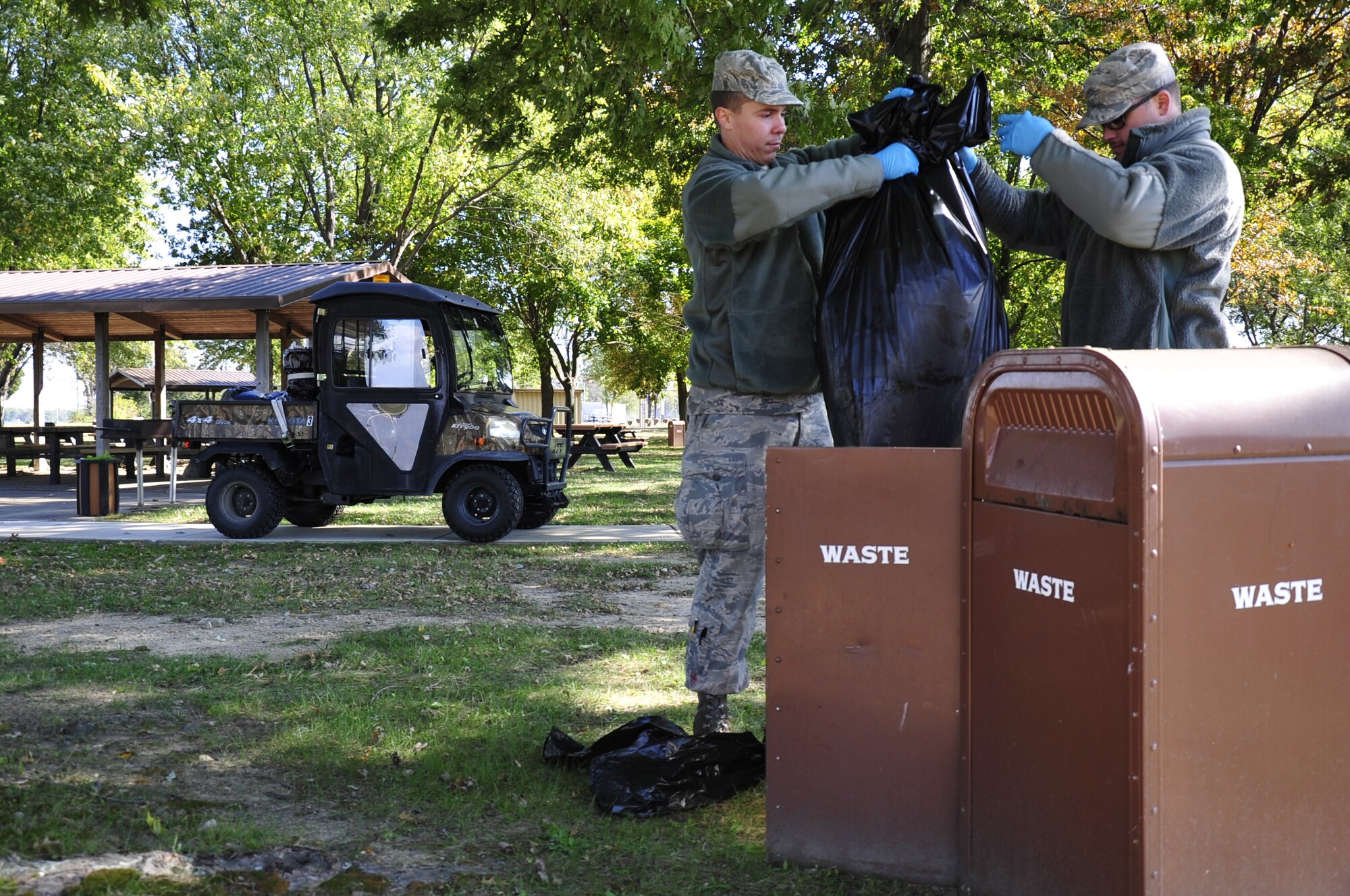 Airman Donald Bailey, 436th Maintenance Squadron jet mechanic, and Airman Jeffrey McMichael, 736th Aircraft Maintenance Squadron maintainer, remove trash from the Eagles Nest Park Oct. 25, 2013, at Dover Air Force Base, Del. Amn Bailey and McMichael are among the first Airmen to work in the new litter patrol program. (U.S. Air Force photo/Airman 1st Class William Johnson)