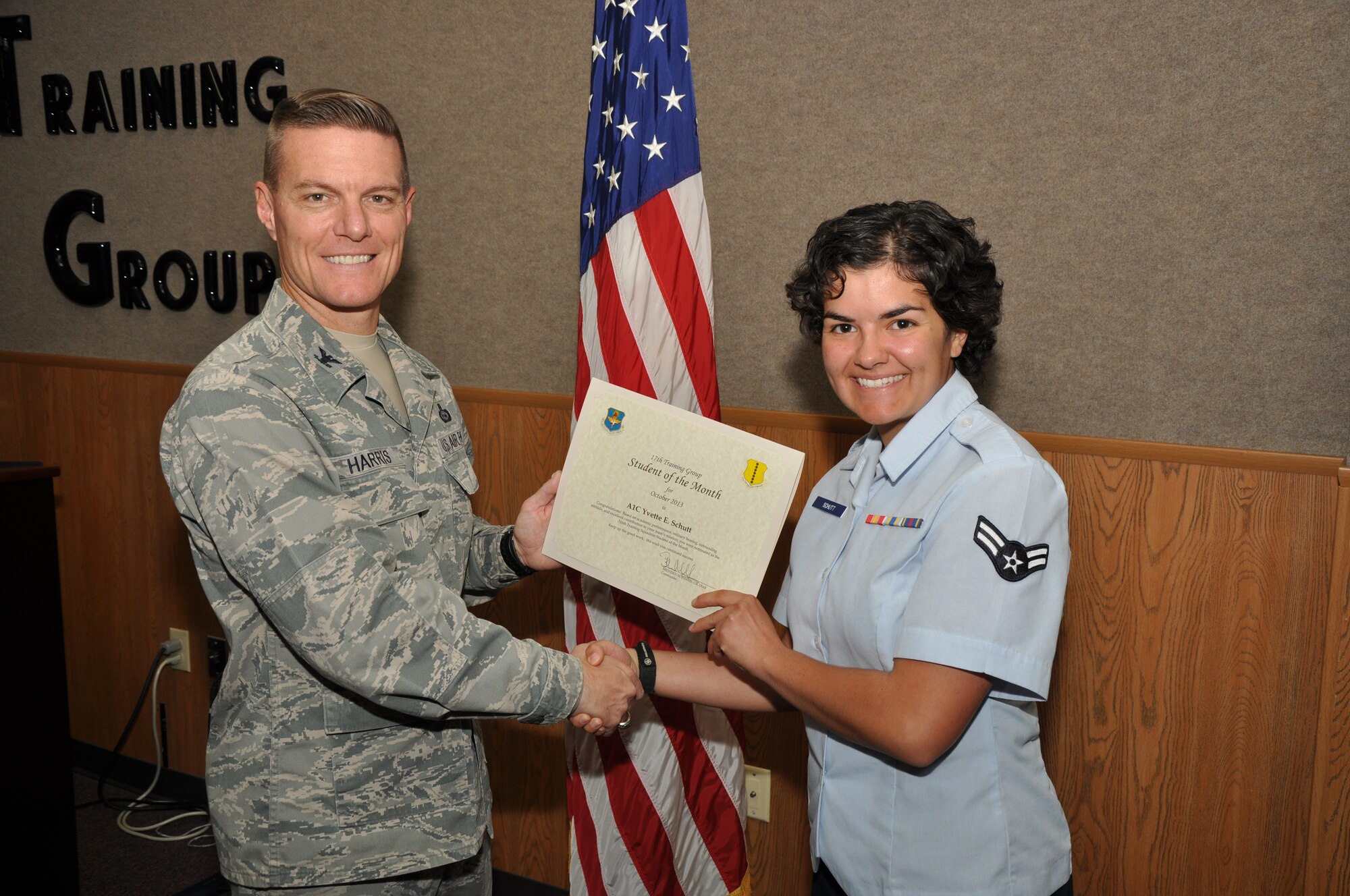 GOODFELLOW AIR FORCE BASE, Texas - Col. Brendan Harris, 17th Training Group Commander, presents the 316th Training Squadron Officer Student of the Month award for May to Airman 1st Class Yvette Schutt, Nov. 1. (U.S. Air Force photo/ Airman 1st Class Joshua Edwards)