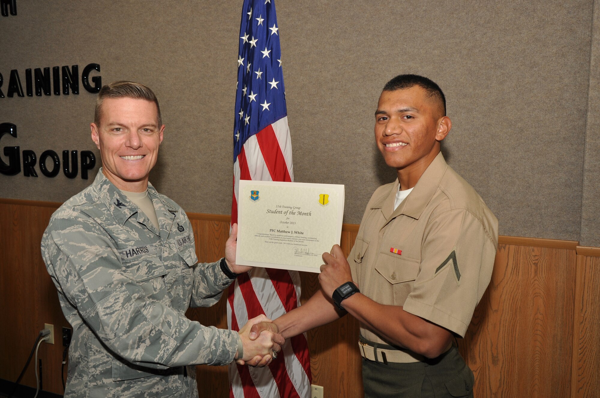 GOODFELLOW AIR FORCE BASE, Texas - Col. Brendan Harris, 17th Training Group Commander, presents the 312th Training Squadron Student of the Month award for October to Marine Corps Pfc. Matthew White, Nov. 1. (U.S. Air Force photo/ Airman 1st Class Joshua Edwards)
