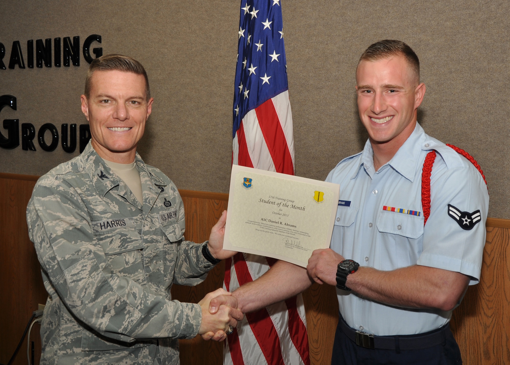 GOODFELLOW AIR FORCE BASE, Texas - Col. Brendan Harris, 17th Training Group Commander, presents the 315th Training Squadron Student of the Month award for October to Airman 1st Class Daniel Abrams, Nov. 1. (U.S. Air Force photo/ Airman 1st Class Joshua Edwards)