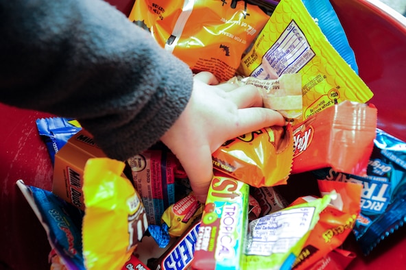 A child reaches into a bowl of candy Oct. 31, 2013, in family housing on Buckley Air Force Base, Colo. Children went house to house collecting candy to celebrate Halloween. (U.S. Air Force photo by Staff Sgt. Christopher Gross/Released) 