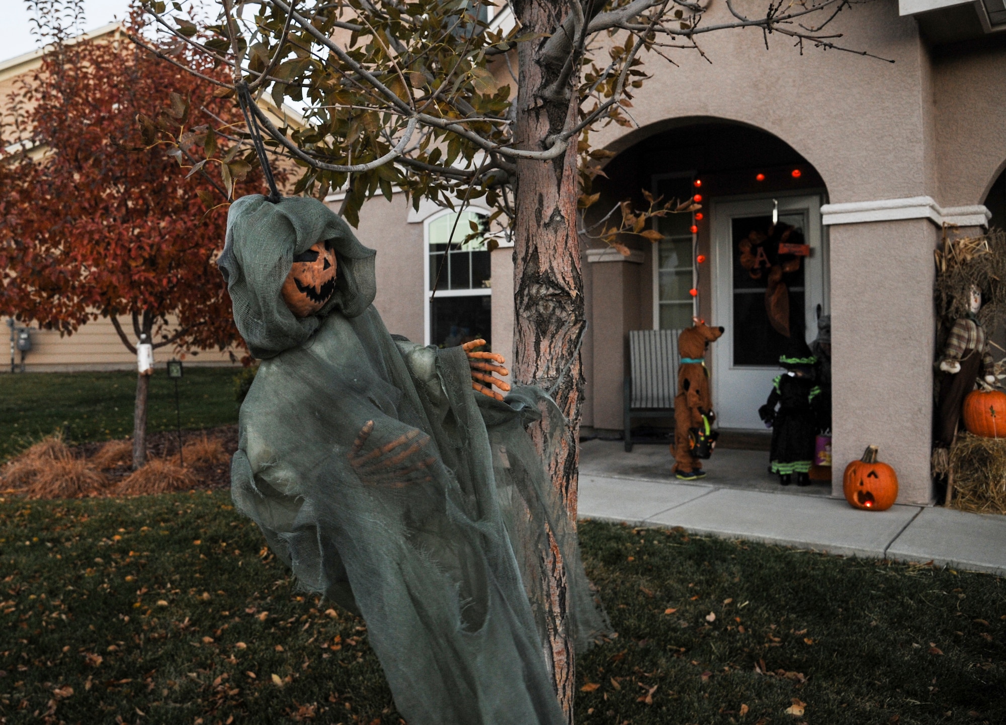 Children go up to a door to collect candy Oct. 31, 2013, in family housing on Buckley Air Force Base, Colo. Children went house to house collecting candy to celebrate Halloween. (U.S. Air Force photo by Staff Sgt. Christopher Gross/Released) 