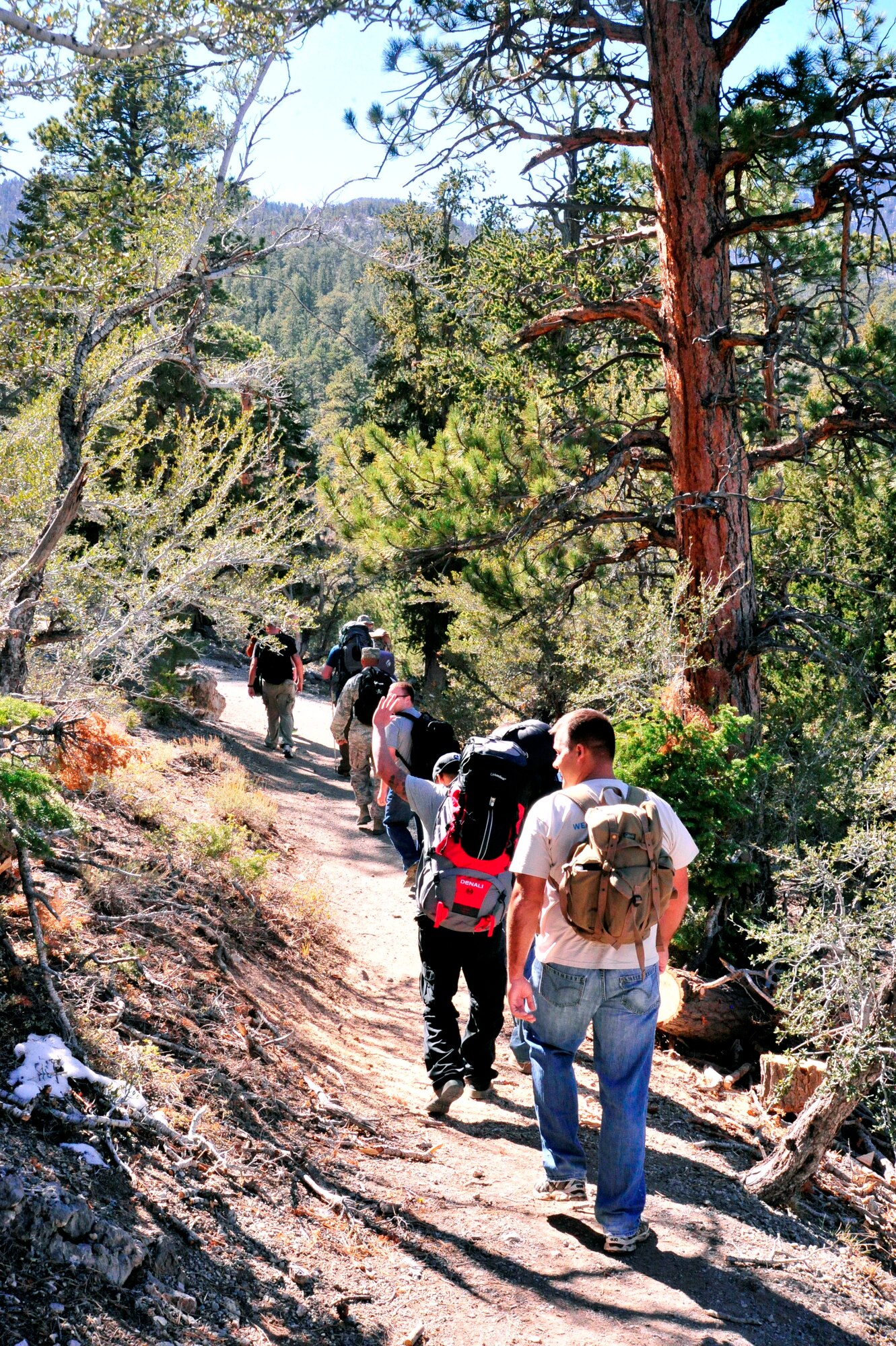 LAS VEGAS, Nev. -- Airmen and family members from the 432nd Operations Support Squadron hike during a memorial ruck march in the Spring Mountains National Recreation Area Oct. 18.  The group hiked 10 kilometers and partnered with Airmen from Camp Bullis, Texas, where the annual event takes place, to raise more than $3,800 to honor security forces Airmen killed in the line of duty during operations Iraqi Freedom and Enduring Freedom.  (U.S. Air Force photo by 1st Lt. S.S./released)