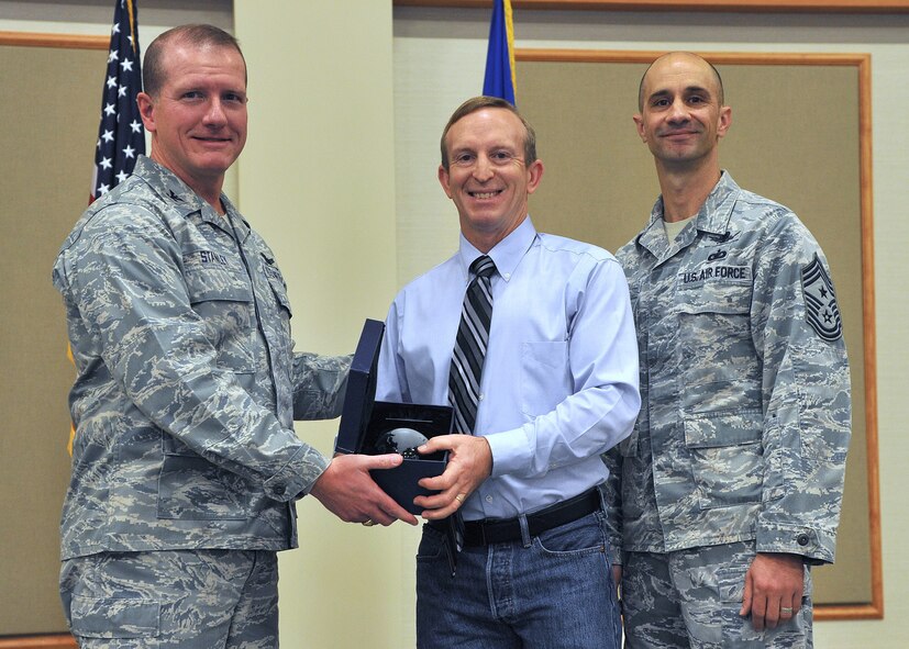 Jeffrey D. Parker, 341st Force Support Squadron, center, was named Malmstrom AFB's Non-Supervisor Category One Civilian of the Quarter for the third quarter of 2013.  Shown presenting the award are Col. Robert W. Stanley II, 341st Missile Wing commander, and Chief Master Sgt. Frank V. Fidani, 341 MW command chief.  The presentation was made at the Wing Quarterly Awards breakfast held Oct. 30 at the Grizzly Bend.  (U.S. Air Force photo/ John Turner)
