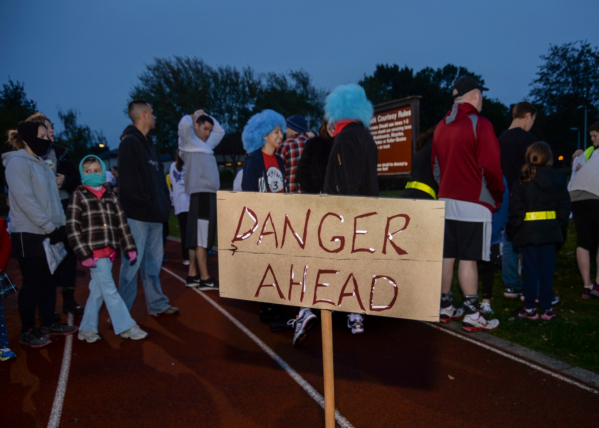 A “Danger Ahead” sign stands as a warning to all participants of the Halloween Zombie Run at the base track on Royal Air Force Lakenheath, England, Oct. 31, 2013. Runners participated in a 30-minute course around the installation while evading “get ya” zombies blocking their paths. (U.S. Air Force photo by Airman 1st Class Nigel Sandridge/Released)
