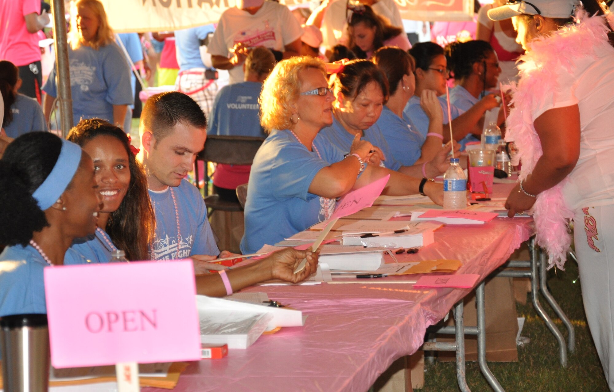 Volunteers from the 45th Space Wing work at the registration tent preparing participants in the Making Strides Against Breast Cancer walk at Space Coast Stadium Oct. 19, 2013. (U.S. Air Force photo/2nd Lt. Nelly Slaughter)