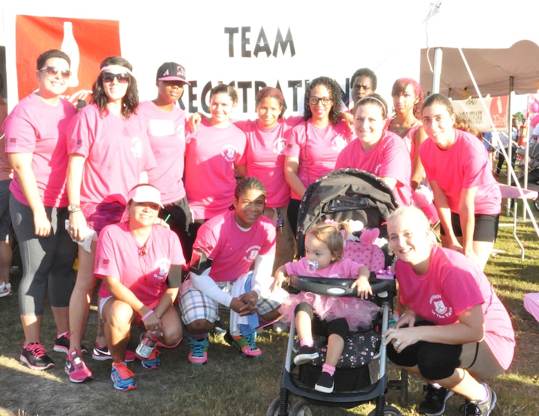 Members of the 45th Security Forces Squadron take time to pose for a picture following the Making Strides Against Breast Cancer walk at Space Coast Stadium Oct. 19, 2013. (U.S. Air Force photo/Nelly Slaughter)