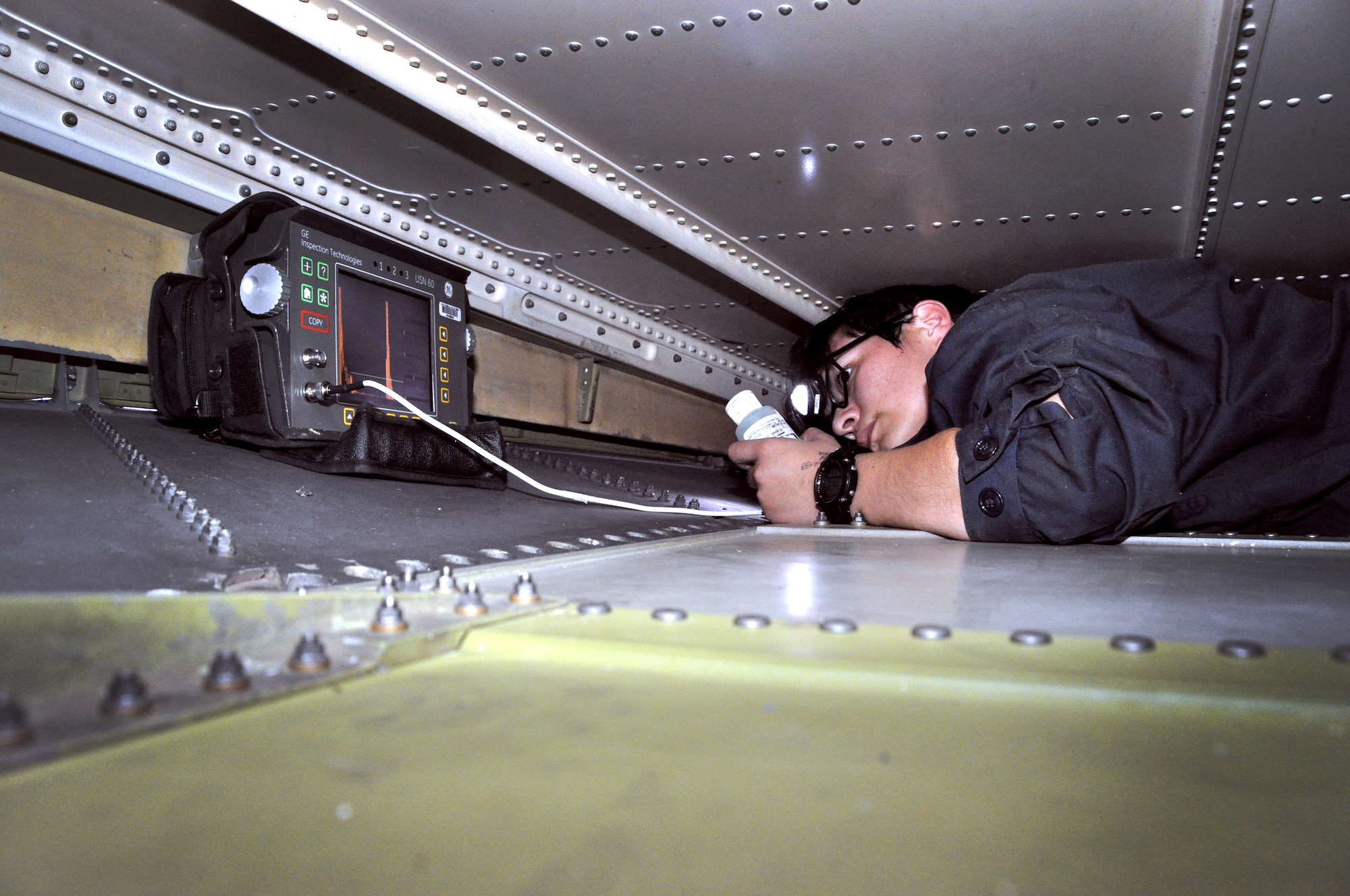 Airman 1st Class Felicia Ramirez, 349th MXS NDI technician, performs an ultrasound inspection Oct. 22 on the metal surface inside the tail section of a KC-10 Extender.(U.S. Air Force photo/Staff Sgt. Patrick Harrower)