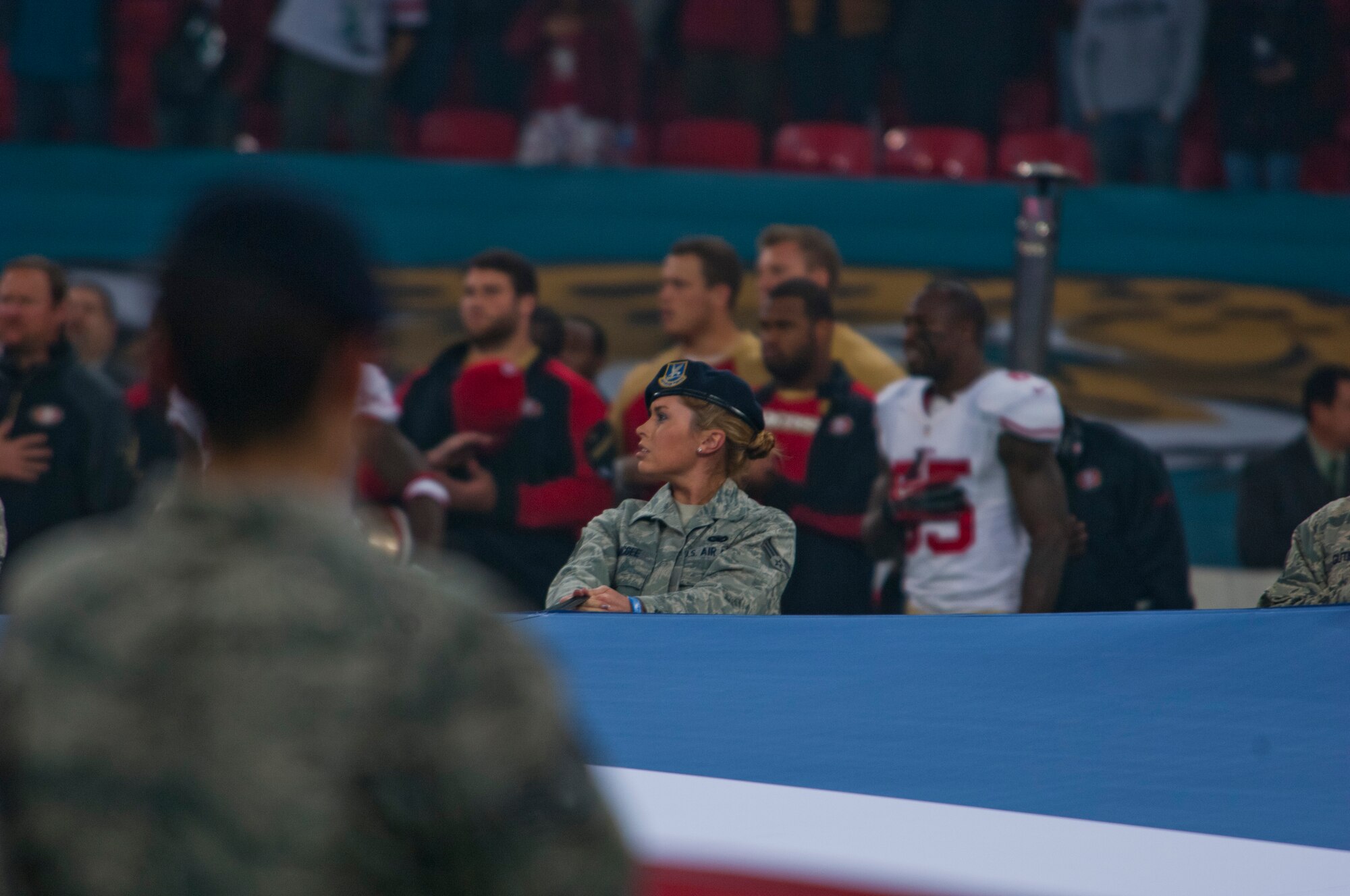 Senior Airman Lindsay McGee, 48th Security Forces Squadron pass and registration clerk, helps hold the U.K. flag at Wembley Stadium, London, just prior to the kick-off of the NFL International Series game between the San Francisco 49ers and Jacksonville Jaguars Oct. 27, 2013. The pregame pageantry also included a joint forces honor guard from Royal Air Force Feltwell and a performance by recording artist Ne-Yo. (U.S. Air Force photo by 2nd Lt. Keenan Kunst/Released) 
