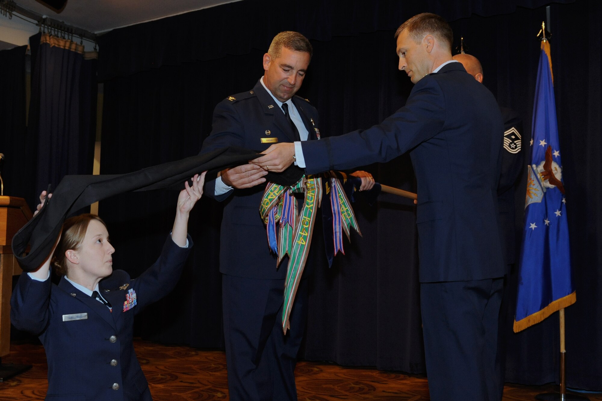 Col. John Hanna, left, 56th Operation Group commander, unfurls the 61st Fighter Squadron banner with incoming commander Lt. Col. Michael Ebner, during the reactivation ceremony Oct. 25.  The 61st FS will be Luke Air Force Base’s first squadron to fly the F-35A Lightning II. (U.S. Air Force photo/Airman 1st Class Pedro Mota)