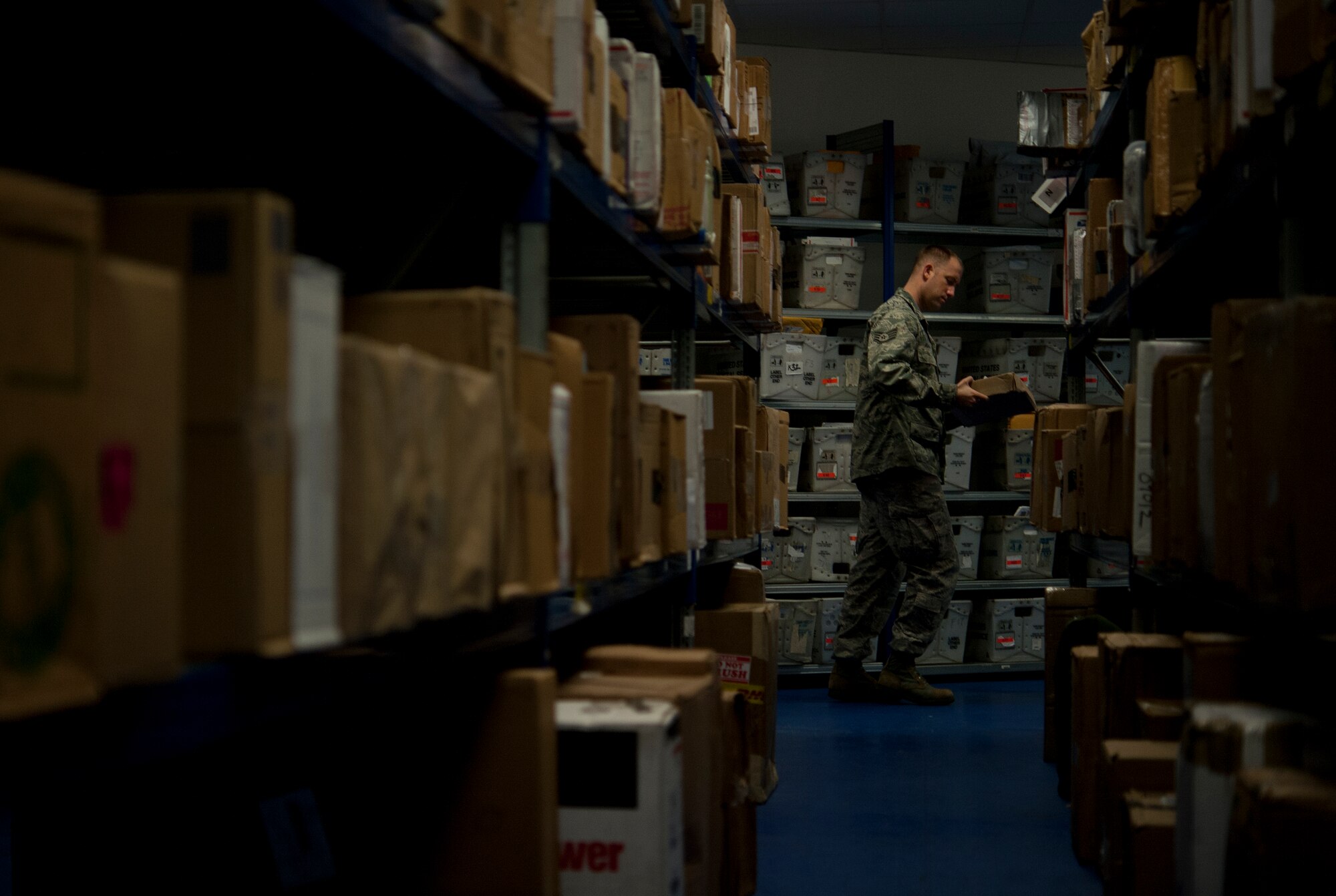 Staff Sgt. Chad Adamczyk, 603rd Air Communications Squadron configuration management supervisor, double checks the name on a package at the Northside Post Office Oct. 24, 2013, Ramstein Air Base, Germany. Adamczyk spends time volunteering at the post office to help relieve some of the holiday workload postal employees receive during the holidays. (U.S. Air Force photo/Senior Airman Damon Kasberg)
