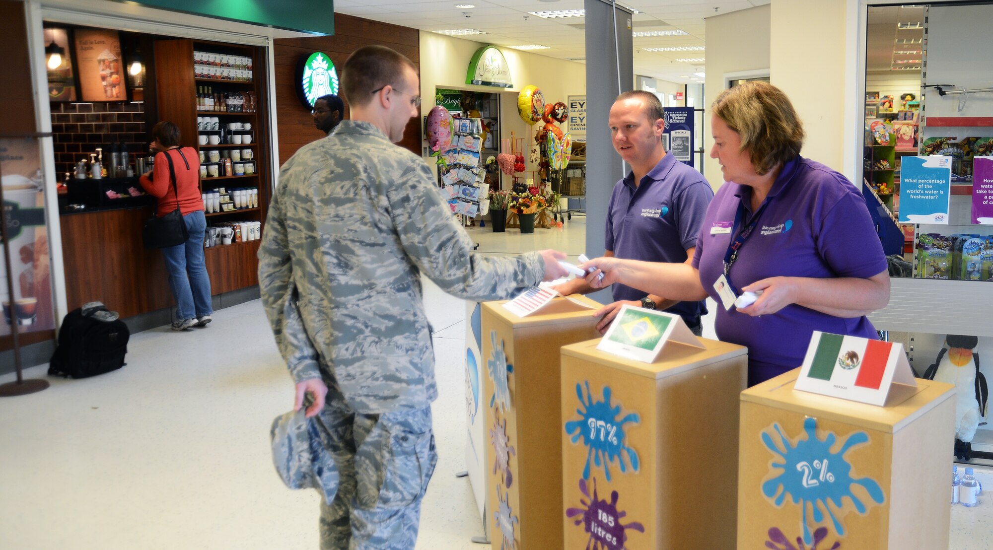 Capt. David Sayers, 48th Medical Operations Squadron pediatrician, participates in a quiz game hosted by Anglian Water at the Royal Air Force Lakenheath, England, Exchange Oct. 24, 2013. Anglian Water, which provides services for RAFs Lakenheath, Feltwell and Mildenhall, hosted the information booth on water conservation as part of the base’s Energy Action Month activities. “If I can get one person to turn off the tap while brushing their teeth, then job done,” said Christine Buchan, Anglian Water representative.  (U.S. Air Force photo by Staff Sgt. Thomas Trower/Released)