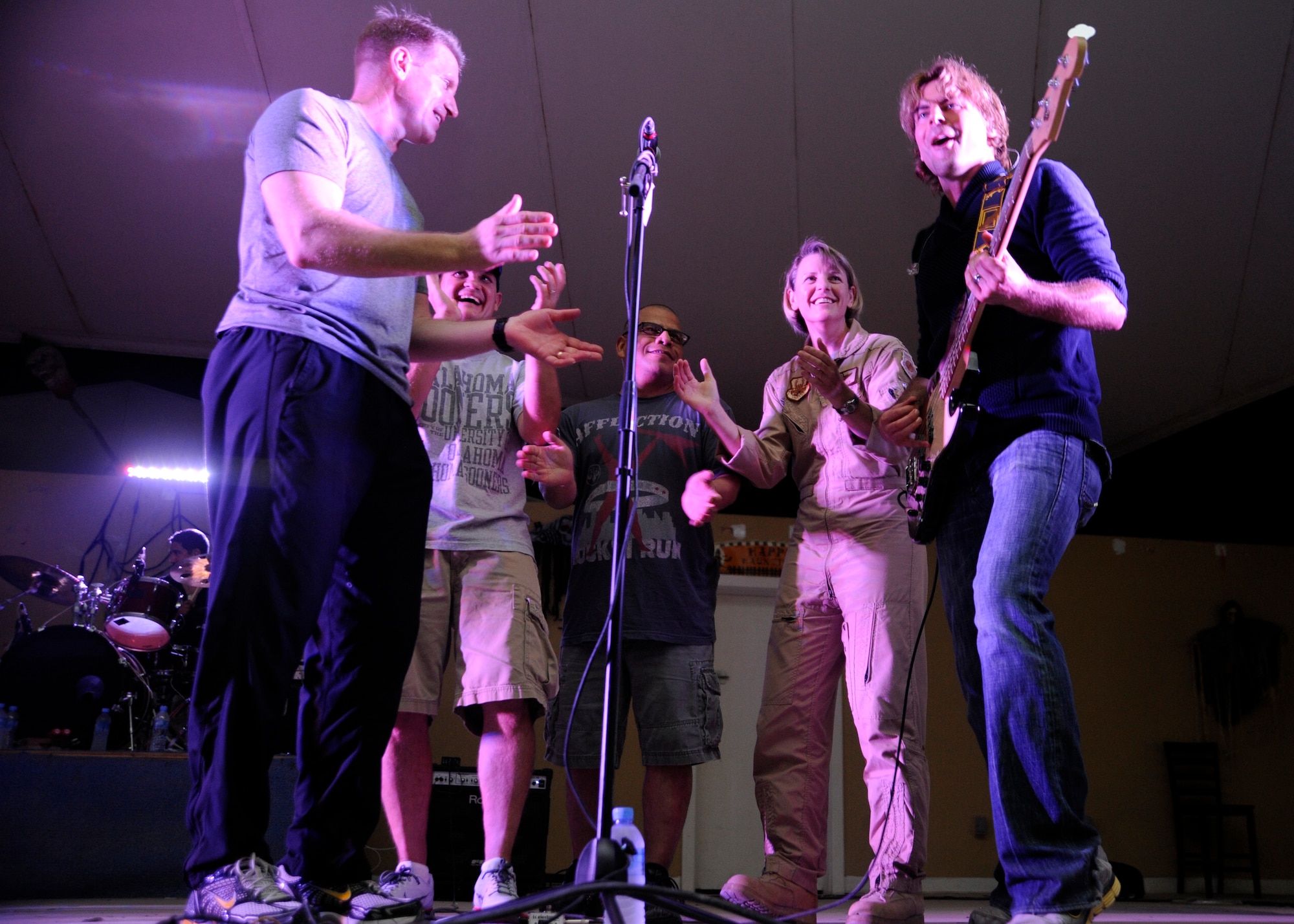 379th Air Expeditionary Wing leaders join country band, the “Lost Trailers,” on stage during a performance at the 379th Air Expeditionary Wing in Southwest Asia, Oct. 31, 2013. During the 379th Expeditionary Force Support Squadron hosted event, the members expressed their gratitude for military service men and women. (U.S. Air Force photo/Senior Airman Bahja J. Jones) 