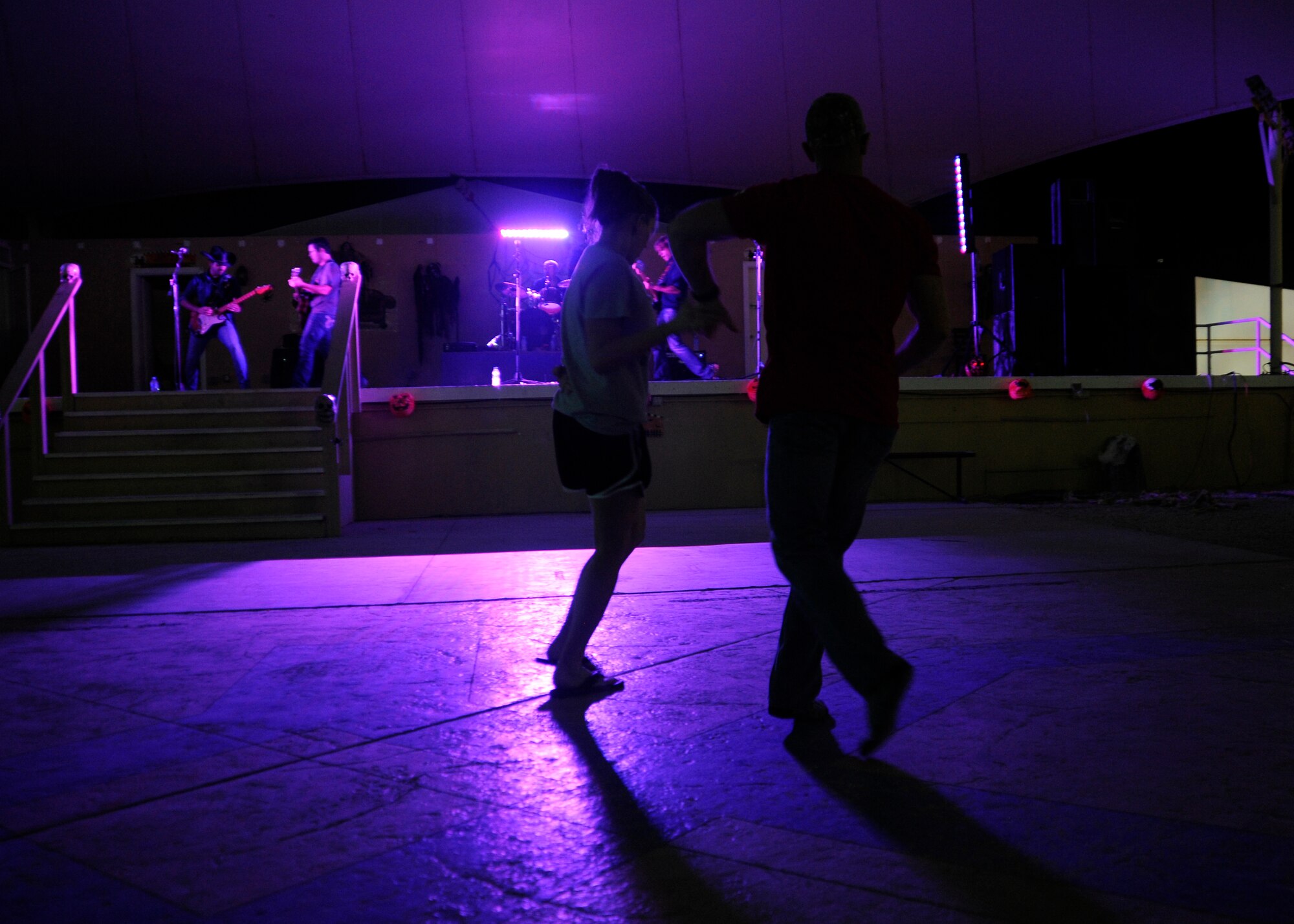 Staff Sgt. Erin Frederick and Staff Sgt. Chris Ericksen dance during a performance by the "Lost Trailers,” an American country band, at the 379th Air Expeditionary Wing in Southwest Asia, Oct. 31, 2013. Frederick is a U.S. Central Command Joint Personnel Recovery Center intelligence specialist deployed from Joint Base Pearl Harbor-Hickam and hails from Lake Park, Fla. Ericksen is a 379th Expeditionary Logistics Readiness Squadron fuels distribution operator deployed from Seymour Johnson Air Force Base, N.C. (U.S. Air Force photo/Senior Airman Bahja J. Jones) 