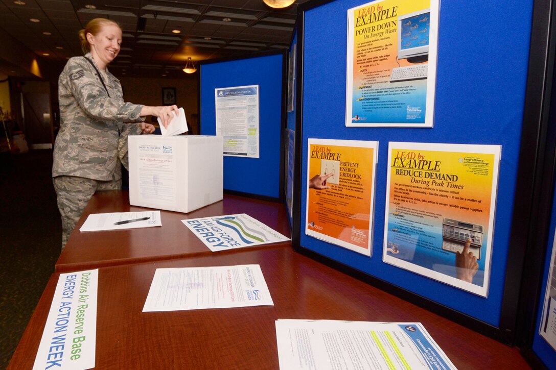 Members of Dobbins Air Reserve Base, Ga. participate in a drawing for a $25 Base Exchange Gift card by completing a short Energy Action Trivia Sheet, celebrating Air Force Energy Action Month, Oct. 24 at the base consolidated club. Dobbins Energy Action Week took place Oct. 21 thru 25, and consisted of awareness, trivia, prizes and members of base civil engineering offering members ways to save energy and resources in their home as well as work areas. (U.S. Air Force photo/Don Peek)