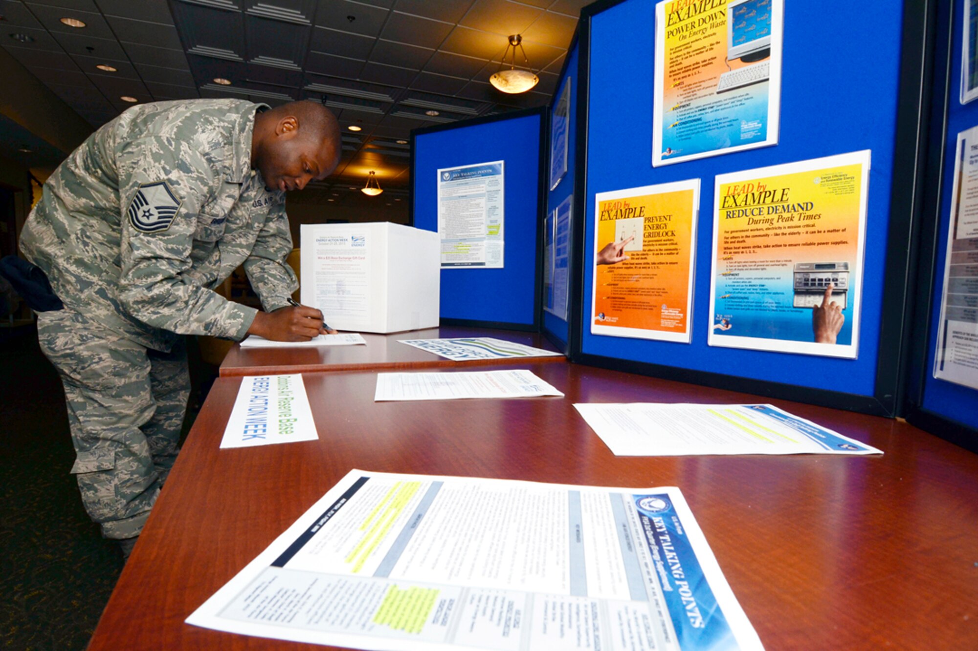 Members of Dobbins Air Reserve Base, Ga. participate in a drawing for a $25 Base Exchange Gift card by completing a short Energy Action Trivia Sheet, celebrating Air Force Energy Action Month, Oct. 24 at the base consolidated club. Dobbins Energy Action Week took place Oct. 21 thru 25, and consisted of awareness, trivia, prizes and members of base civil engineering offering members ways to save energy and resources in their home as well as work areas. (U.S. Air Force photo/Don Peek)