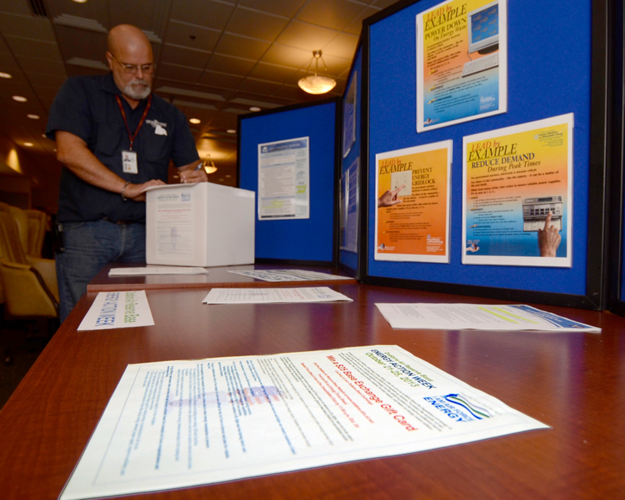 Members of Dobbins Air Reserve Base, Ga. participate in a drawing for a $25 Base Exchange Gift card by completing a short Energy Action Trivia Sheet, celebrating Air Force Energy Action Month, Oct. 24 at the base consolidated club. Dobbins Energy Action Week took place Oct. 21 thru 25, and consisted of awareness, trivia, prizes and members of base civil engineering offering members ways to save energy and resources in their home as well as work areas. (U.S. Air Force photo/Don Peek)
