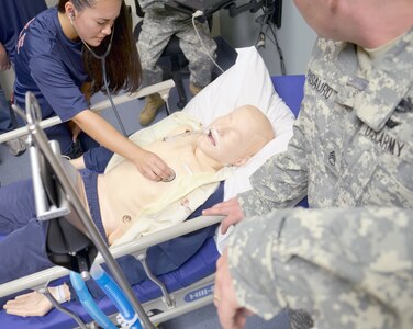 An Army Junior Reserve Officer Training Corps cadet listens to a simulated patient’s lungs while touring the Interservice Respiratory Therapy Program at the Medical Education and Training Campus. The patient simulator is a realistic, full body, wireless adult mannequin used in the IRTP for training respiratory therapy technicians. (Photo by Lisa Braun, Medical Education and Training Campus Public Affairs)