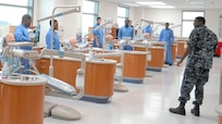 Students in the Navy dental assistant program at the Medical Education and Training Campus receive instruction by Hospital Corpsman 2nd Class Bilal Law (right) during the infection control lab. (Photo by Chief Hospital Corpsman Brenda Muscella, Medical Education and Training Campus Public Affairs)
