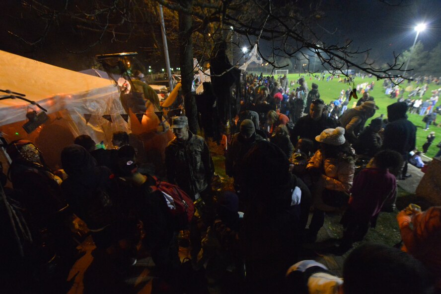 Families from the KMC area ventured along the many tents and trunks guarded by the living dead, outlaws and werewolves for a chance at sweet sugary prizes during the 2013 Halloween Trunk or Treat at Donnely Park, Oct. 31, 2013, Ramstein Air Base, Germany. Trunk or Treat featured goblins, ghouls, monsters, minions, aliens, and dinosaurs, as well as food, games, movies, costume contests and trunks full of candy for eager trick-or-treaters. (U.S. Air Force photo/Airman 1st Class Jordan Castelan)