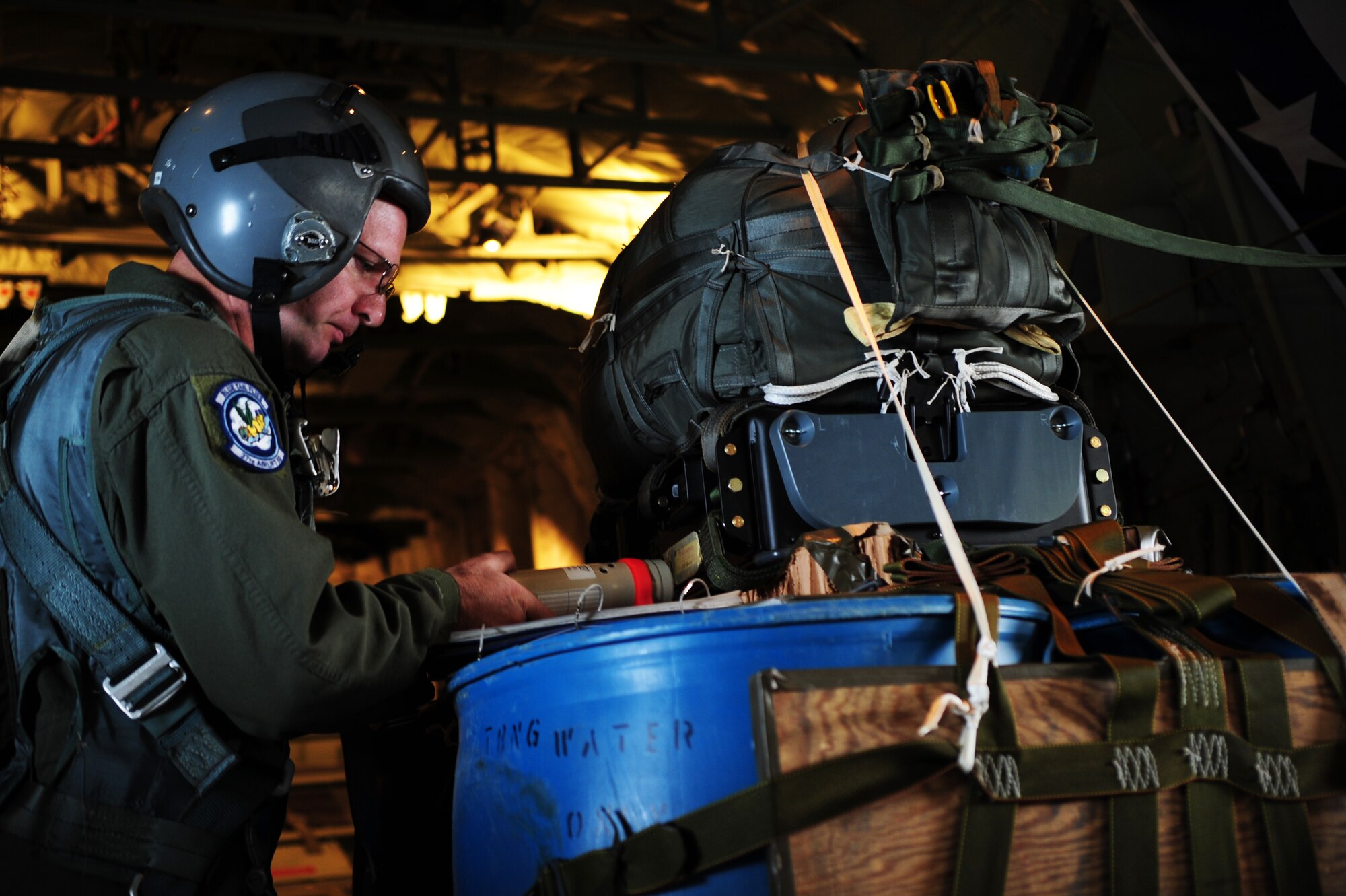 Master Sgt. Jason Beebe, 37th Airlift Squadron loadmaster, prepares the Joint Precision Airdrop System bundle for the first test employment during a joint training mission in Europe, Oct. 23, 2013, Powidz Air Transport Base, Poland. The JPADS is equipped with a GPS, allowing the bundles to land within feet of the point of impact, ensuring they get to war fighters. (U.S. Air Force photo/Senior Airman Hailey Haux)