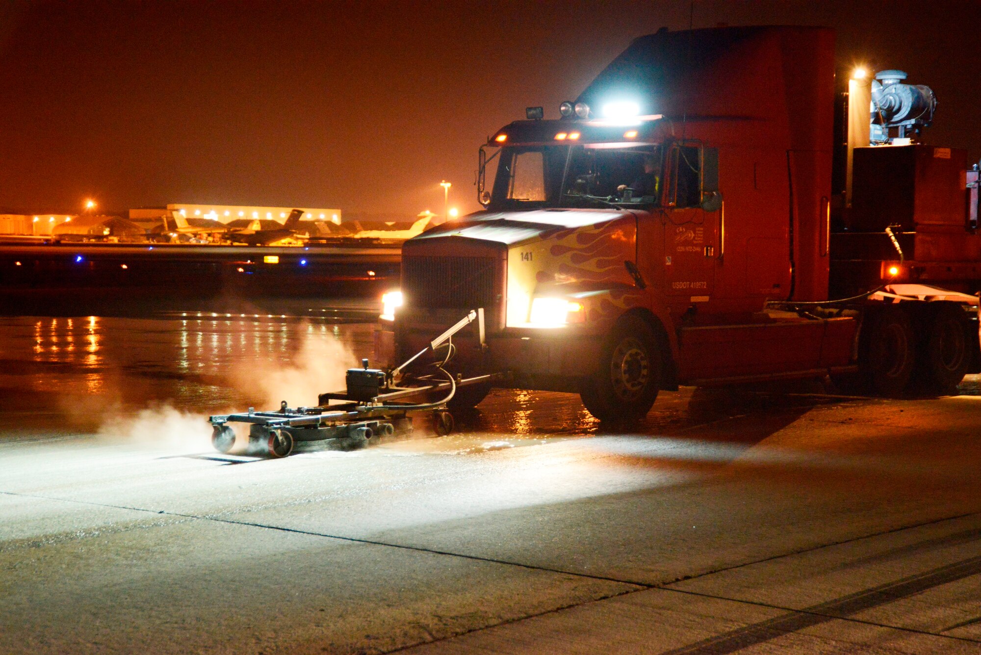 Scott Mansfield, a local contractor, navigates a custom-built 18 wheeler which removes aircraft tire rubber and paint lines from the Robins airfield using high-pressure water for paint at 1,500 PSI and light detergent. Tire rubber particles are then picked up by a sweeper vacuum truck. (U.S. Air Force photo by Ed Aspera)