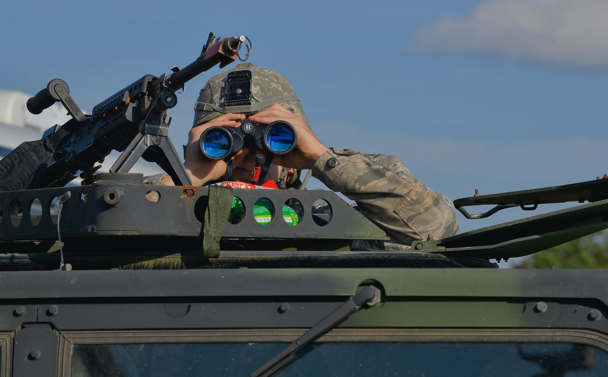 Airman 1st Class Brandon Thompson, 31st Security Forces Squadron creek defender course trainee, scans the horizon in a HUMVEE turret during airfield defense training, Oct. 22, 2013, Baumholder, Germany. Thompson was part of a 98-student class undergoing training to prepare them for deployed conditions around the world. (U.S. Air Force photo/Airman 1st Class Jordan Castelan)