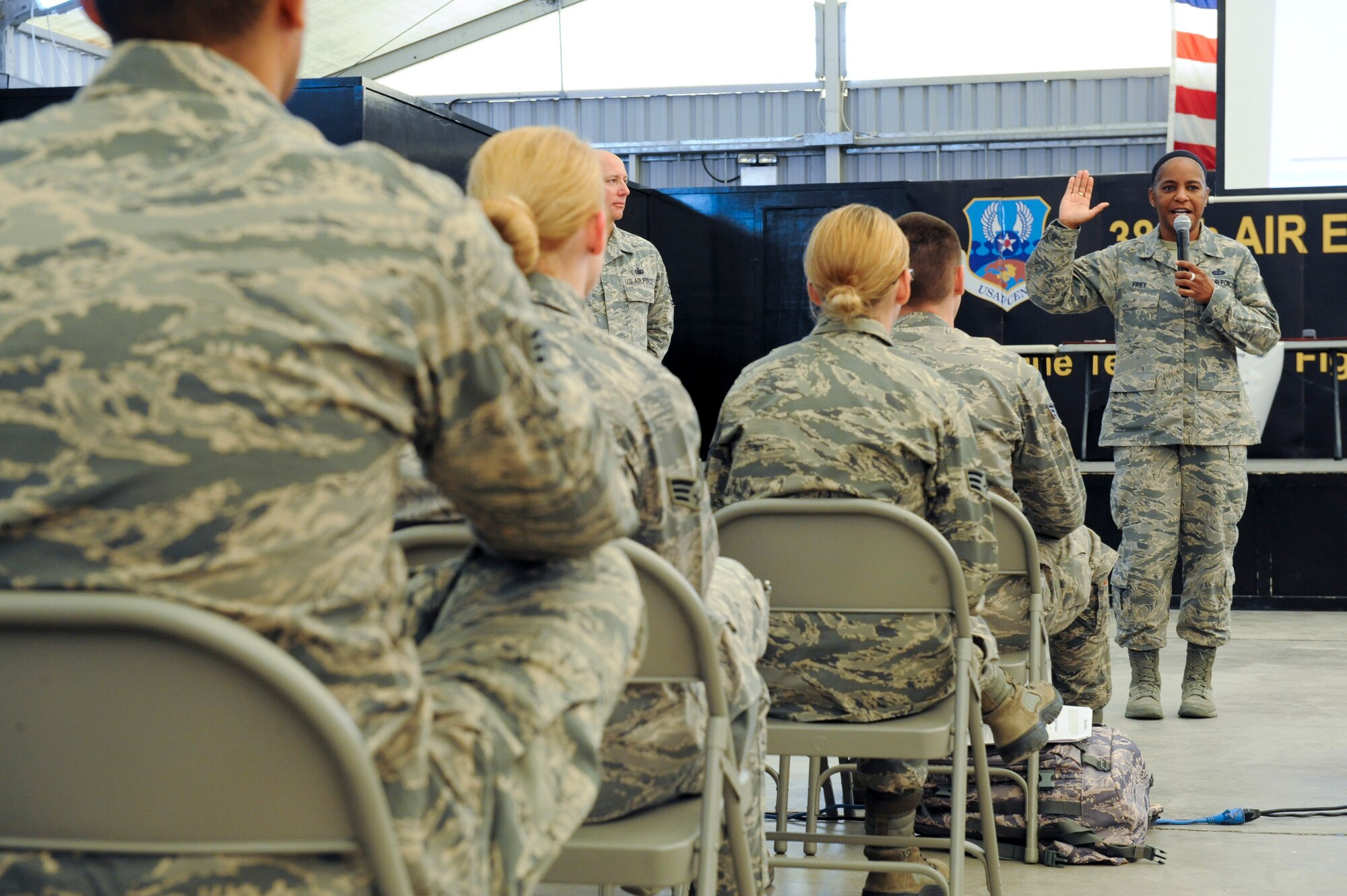 U.S. Air Force Chief Master Sgt. Shelina Frey, United States Air Forces Central Command command chief master sergeant, welcomes newcomers to the 380th Air Expeditionary Wing during “Warrior Welcome” at an undisclosed location in Southwest Asia, Oct. 25, 2013. Frey used the opportunity of speaking to new Airmen to stress the importance of protecting and taking care of each other. Frey said when someone takes the oath it is the leader’s responsibility to provide an environment for Airmen to safely carryout that oath. (U.S. Air Force photo by Staff Sgt. Joshua J. Garcia) 