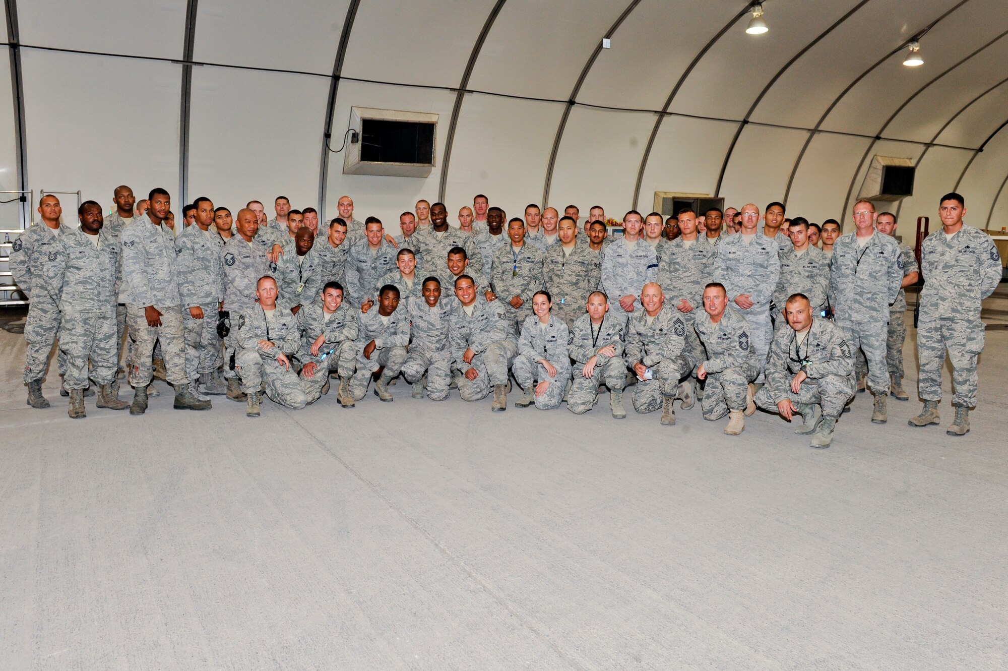 U.S. Air Force Chief Master Sgt. Shelina Frey, United States Air Forces Central Command command chief master sergeant, first row center, poses with Airmen from the 380th Expeditionary Maintenance Group at an undisclosed location in Southwest Asia, Oct. 23, 2013.  Frey visited with Airmen around the wing communicating U.S. Air Forces Central Command Commander Lt. Gen. John Hesterman’s priority of “protect and take care of each other.” (U.S. Air Force photo by Staff Sgt. Joshua J. Garcia)
