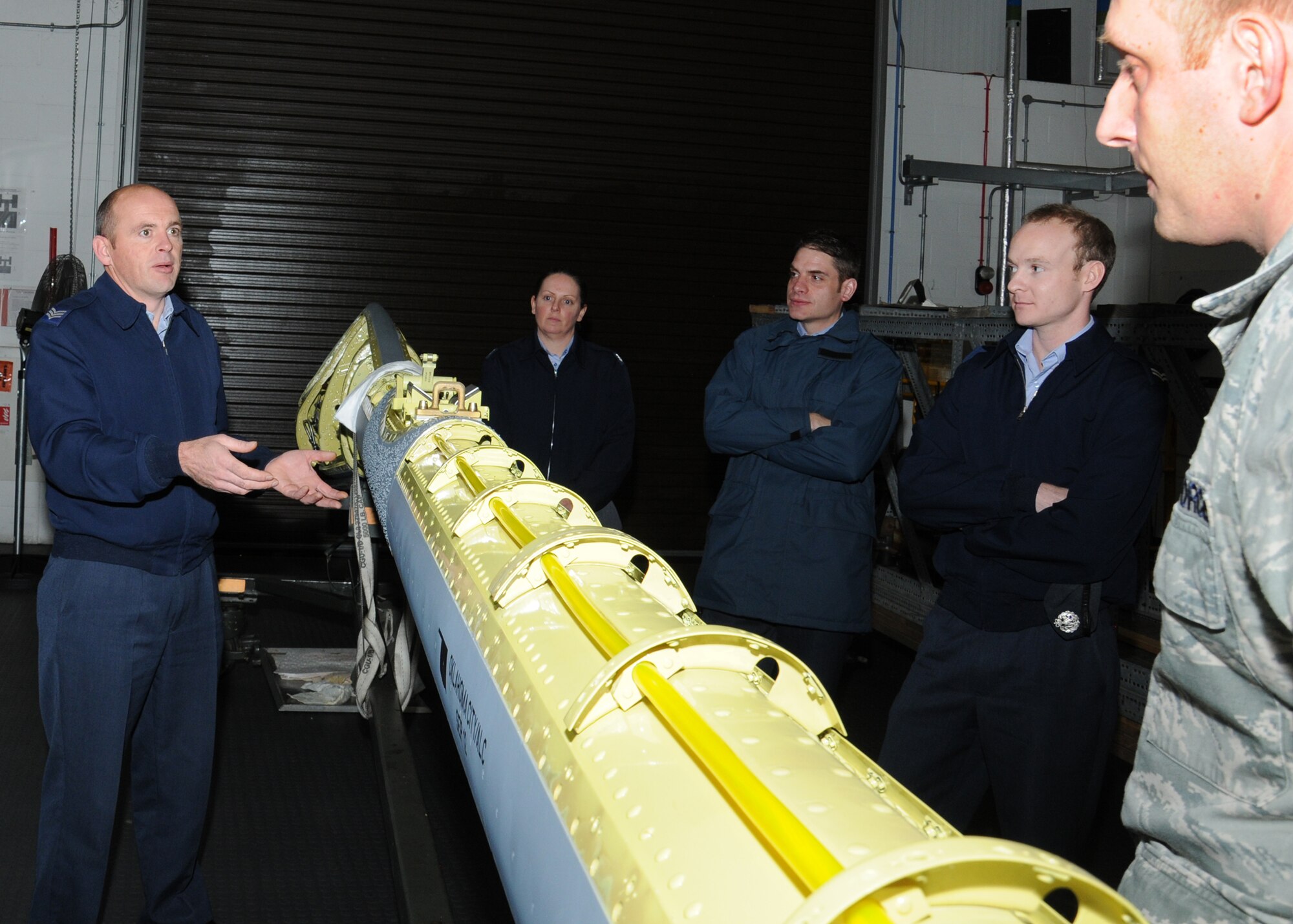 Royal Air Force Sgt. Phill Nightingale, left, RAF Marham quality and continuous improvement team facilitator, discusses opportunities to streamline processes and create synergy between the 100th Logistics Readiness Squadron and the 100th Maintenance Squadron with other RAF Marham members and U.S. Air Force Tech. Sgt. Ron Cooney, right, 100th MXS NCO in charge of the maintenance analysis section from Johnstown, Pa., Oct. 30, 2013, on RAF Mildenhall, England. Members of RAF Marham were invited as a partnership-building effort to share their quality and continuous improvement team’s experiences and to benchmark good maintenance practices. This meeting was set up following the 100th LRS and the 100th MXS commanders request to identify top priories. (U.S. Air Force photo by Gina Randall/Released) 