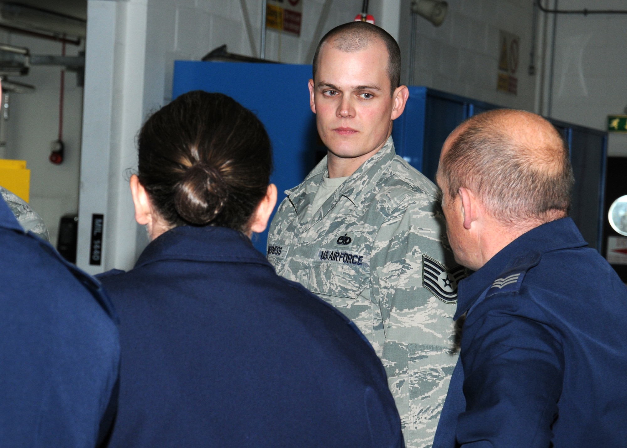 U.S. Air Force Tech. Sgt. Eric Vangsness, 100th Maintenance Squadron Hydraulics backshop assistant section chief from Decorah, Iowa, discusses opportunities to streamline processes and create synergy between the 100th Logistics Readiness Squadron and the 100th MXS Oct. 30, 2013, on RAF Mildenhall, England. Members of RAF Marham were invited as a partnership-building effort to share their quality and continuous improvement team’s experiences and to benchmark good maintenance practices. These RAF Marham service members are maintainers and also work for their quality assurance section. (U.S. Air Force photo by Gina Randall/Released)