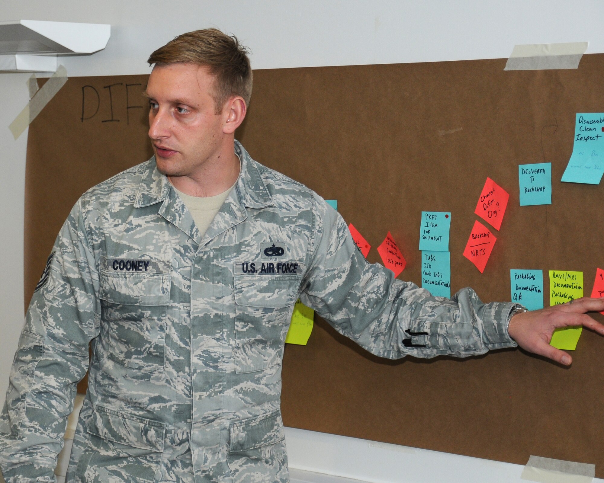 U.S. Air Force Tech. Sgt. Ron Cooney, 100th Maintenance Squadron NCO in charge of the maintenance analysis section from Johnstown, Pa., discusses opportunities to streamline processes and create synergy between the 100th Logistics Readiness Squadron and the 100th MXS Oct. 30, 2013, on RAF Mildenhall, England. Members of RAF Marham were invited as a partnership-building effort to share their quality and continuous improvement team’s experiences and to benchmark good maintenance practices. Cooney’s goal was to look at areas of concern and find ways to correct them. (U.S. Air Force photo by Gina Randall/Released) 