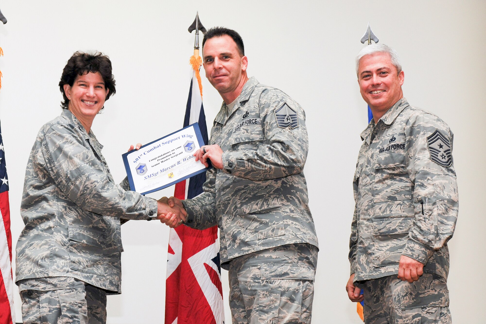 RAF ALCONBURY, United Kingdom – Master Sgt. Marcus Webb, 501st Combat Support Wing, receives his certificate for promotion to senior master sergeant from Col. Angela Cadwell, 501st Combat Support Wing commander, and Chief Master Sgt. Robert Sealey, 501st CSW command chief, during a promotion ceremony at RAF Alconbury Oct. 31. (U.S. Air Force photo by Staff Sgt. Brian Stives)