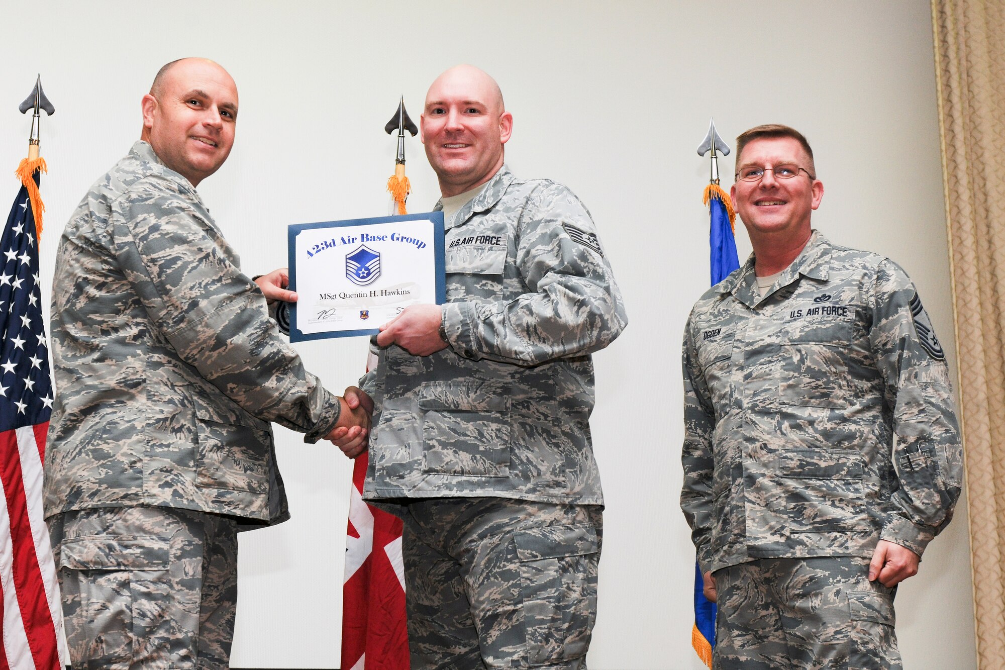 RAF ALCONBURY, United Kingdom – Tech. Sgt. Quentin Hawkins, 423rd Communications Squadron, receives his certificate for promotion to master sergeant from Col. Steve Sweeney, 423rd Air Base Group commander, and Chief Master Sgt. Michael Ogden, 423rd ABG superintendent, during a promotion ceremony at RAF Alconbury Oct. 31. (U.S. Air Force photo by Staff Sgt. Brian Stives)
