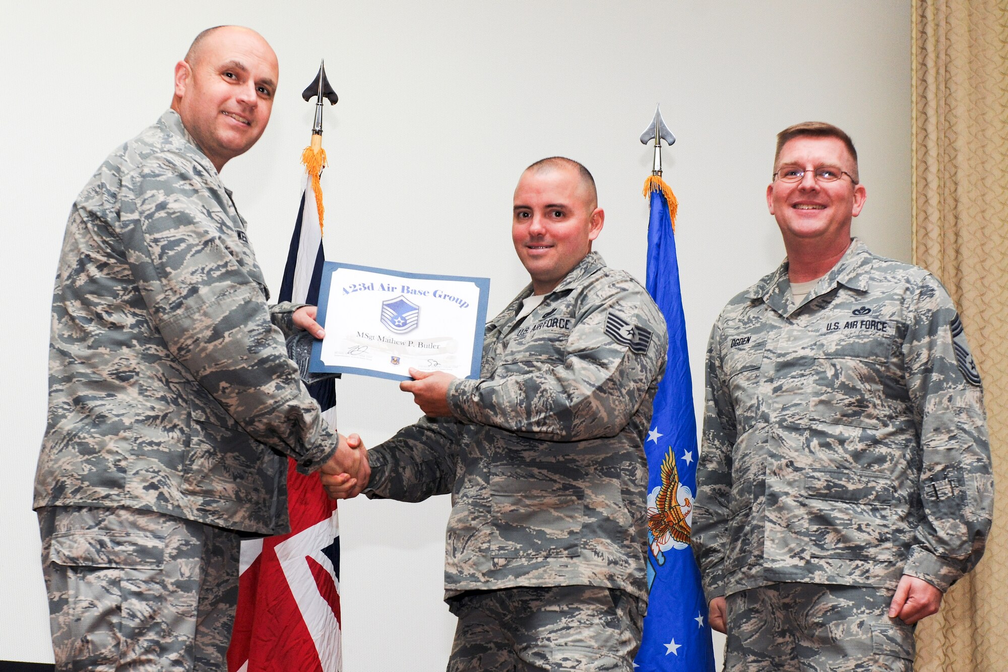 RAF ALCONBURY, United Kingdom – Tech. Sgt. Mathew Butler, 423rd Security Forces Squadron, receives his certificate for promotion to master sergeant from Col. Steve Sweeney, 423rd Air Base Group commander, and Chief Master Sgt. Michael Ogden, 423rd ABG superintendent, during a promotion ceremony at RAF Alconbury Oct. 31. (U.S. Air Force photo by Staff Sgt. Brian Stives)