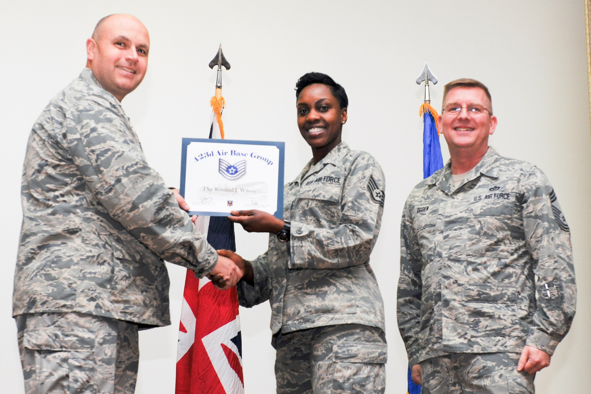 RAF ALCONBURY, United Kingdom – Staff Sgt. Rosalind Wilson, 423rd Air Base Group, receives her certificate for promotion to technical sergeant from Col. Steve Sweeney, 423rd Air Base Group commander, and Chief Master Sgt. Michael Ogden, 423rd ABG superintendent, during a promotion ceremony at RAF Alconbury Oct. 31. (U.S. Air Force photo by Staff Sgt. Brian Stives)