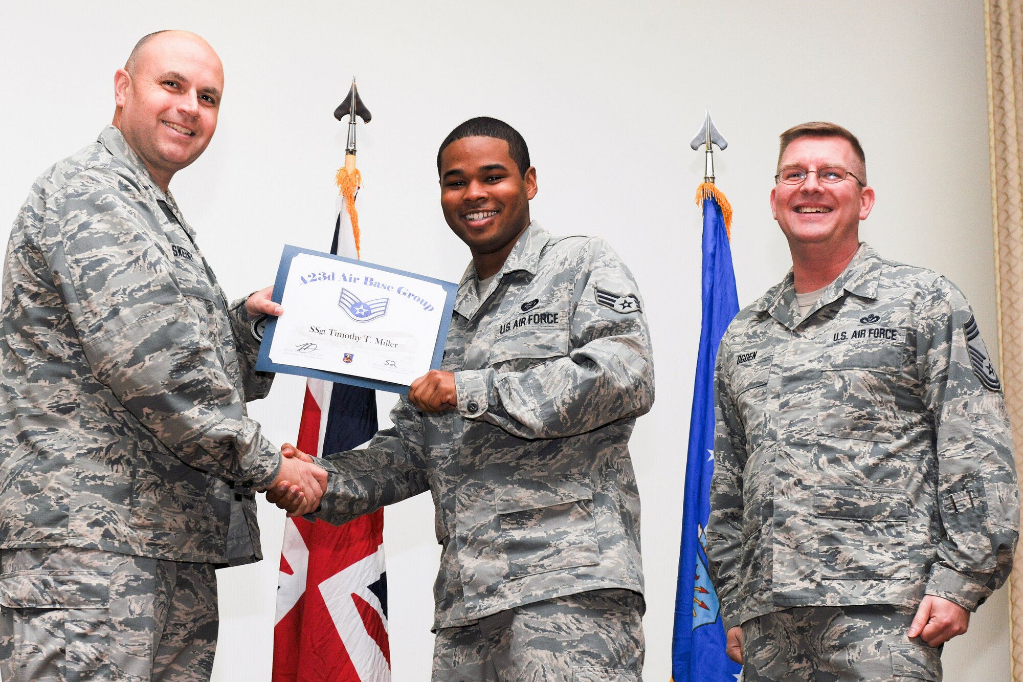 RAF ALCONBURY, United Kingdom – Senior Airman Timothy Miller, 423rd Force Support Squadron, receives his certificate for promotion to staff sergeant from Col. Steve Sweeney, 423rd Air Base Group commander, and Chief Master Sgt. Michael Ogden, 423rd ABG superintendent, during a promotion ceremony at RAF Alconbury Oct. 31. (U.S. Air Force photo by Staff Sgt. Brian Stives)